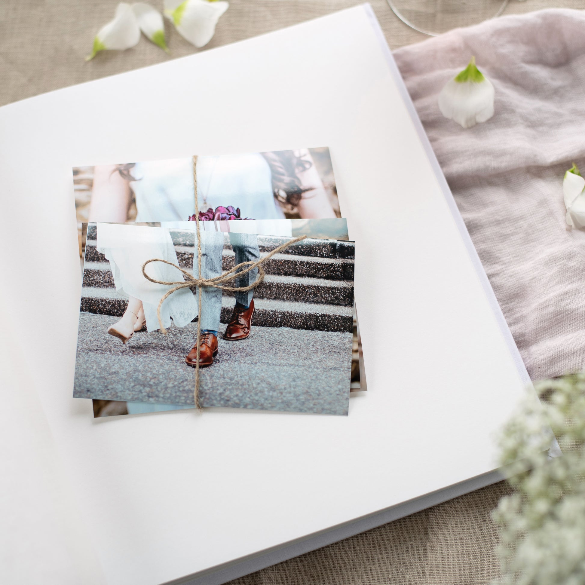 A stylish white Goldbuch photo album with a luxurious gold leaf design, perfect for preserving cherished memories.