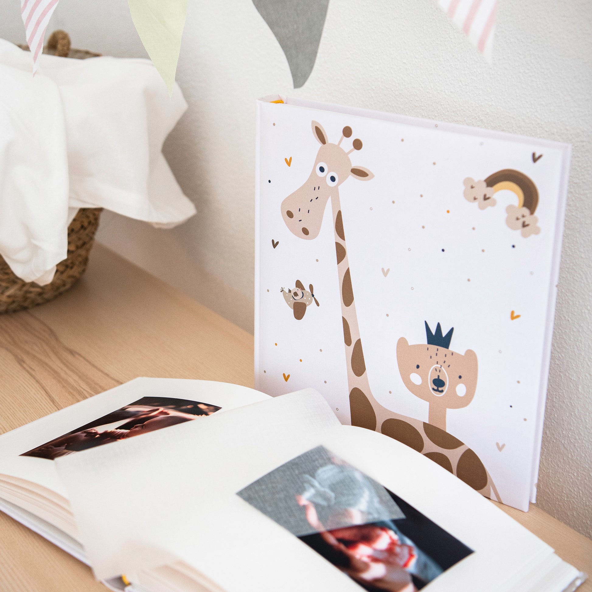 A Goldbuch baby photo album featuring a charming cover with a giraffe and a bear, perfect for capturing precious memories.