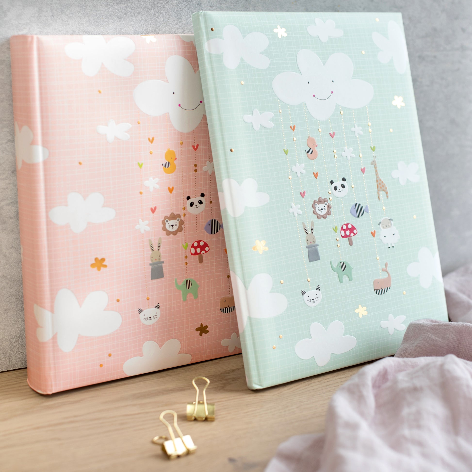 A delightful Goldbuch baby photo album decorated with various animals and soft, fluffy clouds.