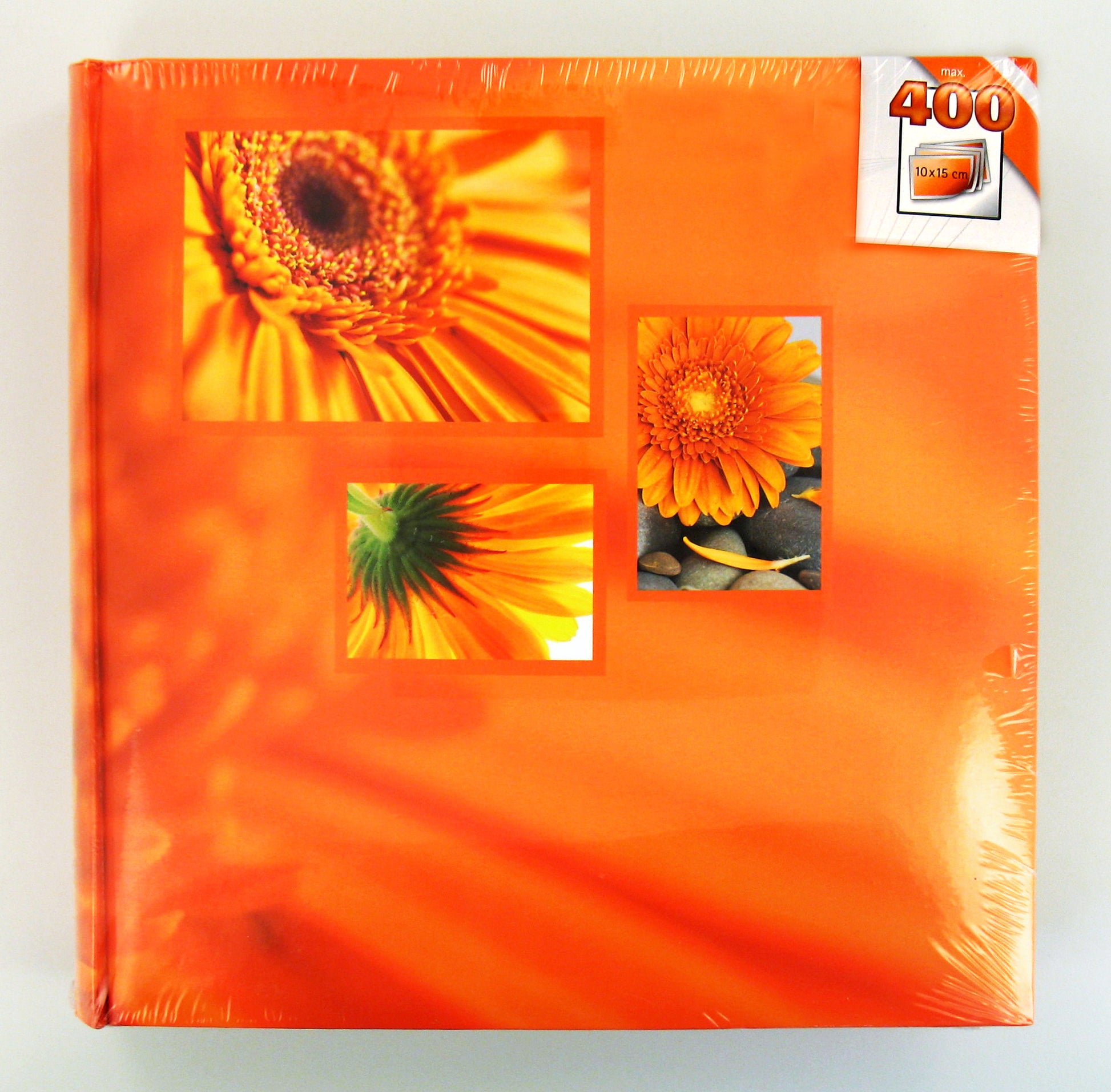 A orange Hama photo album displaying various pictures of orange flowers, highlighting their unique shapes.