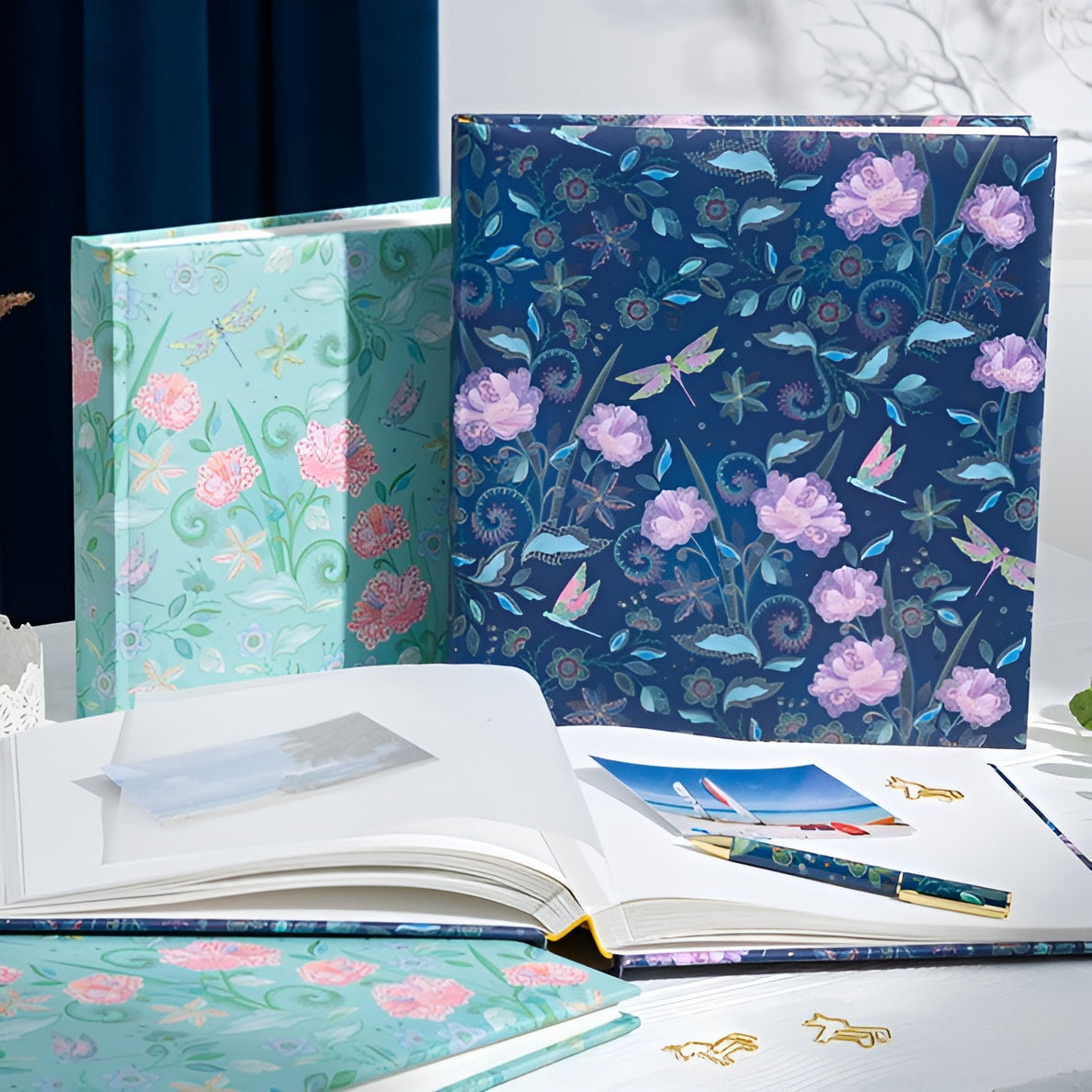 A vibrant green Goldbuch photo album featuring pink flowers and butterflies, indicative of a decorative photo album.