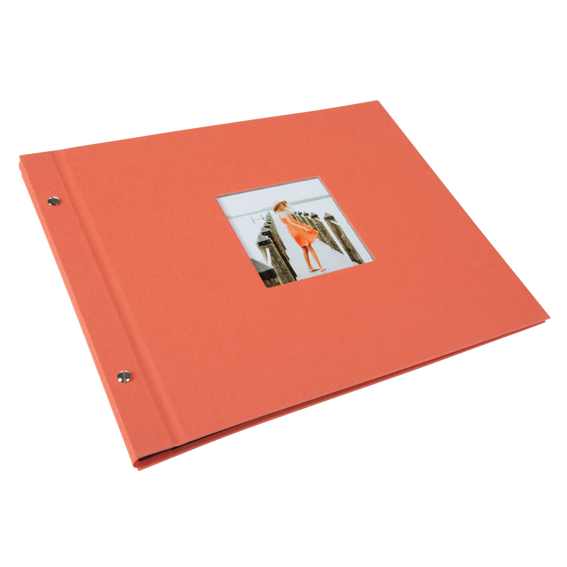 A coral Goldbuch photo album with a woman walking on a deck, showcasing a serene waterfront scene.