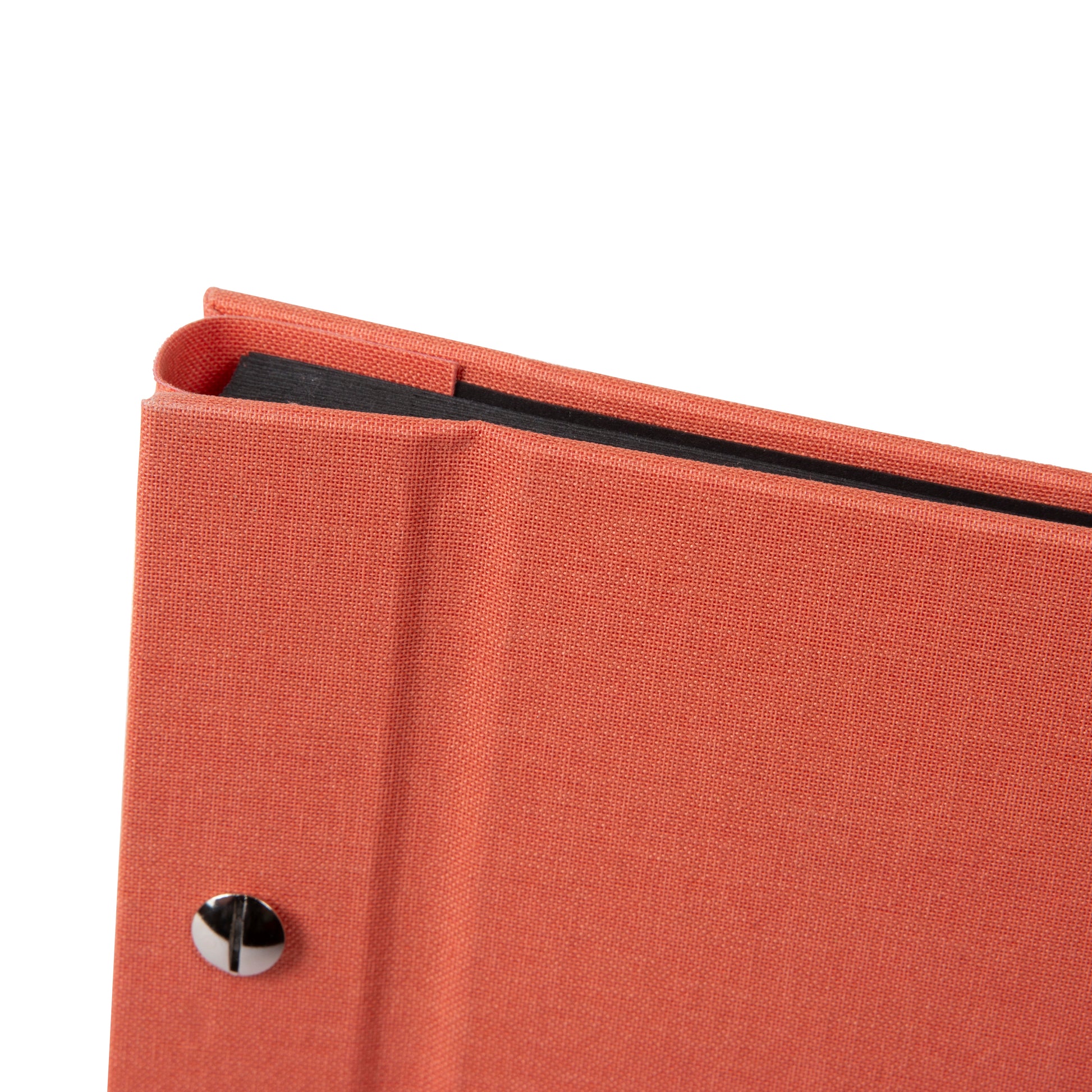 A coral Goldbuch photo album with a woman walking on a deck, showcasing a serene waterfront scene.