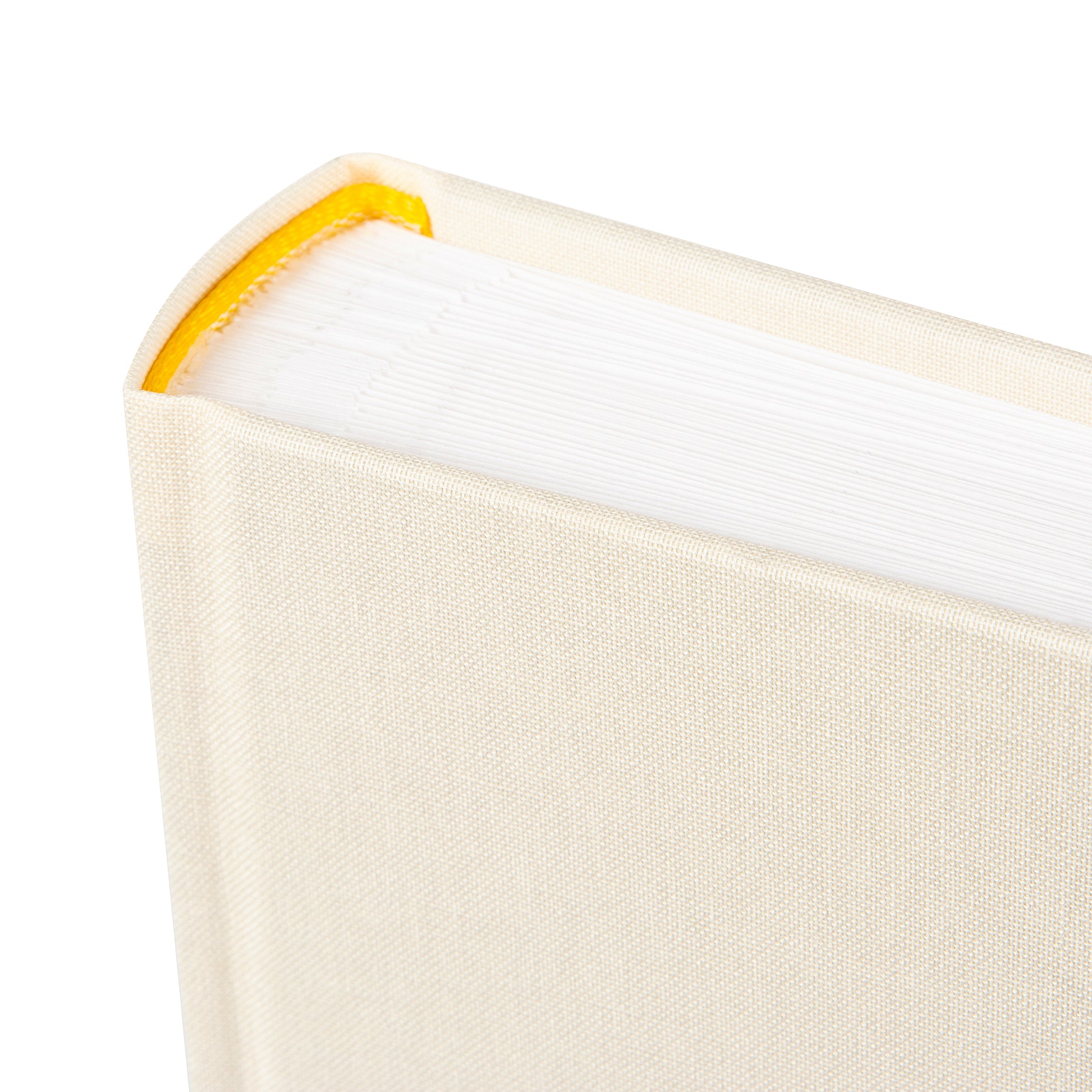 A Goldbuch photo album with three photographs showcased on its surface.