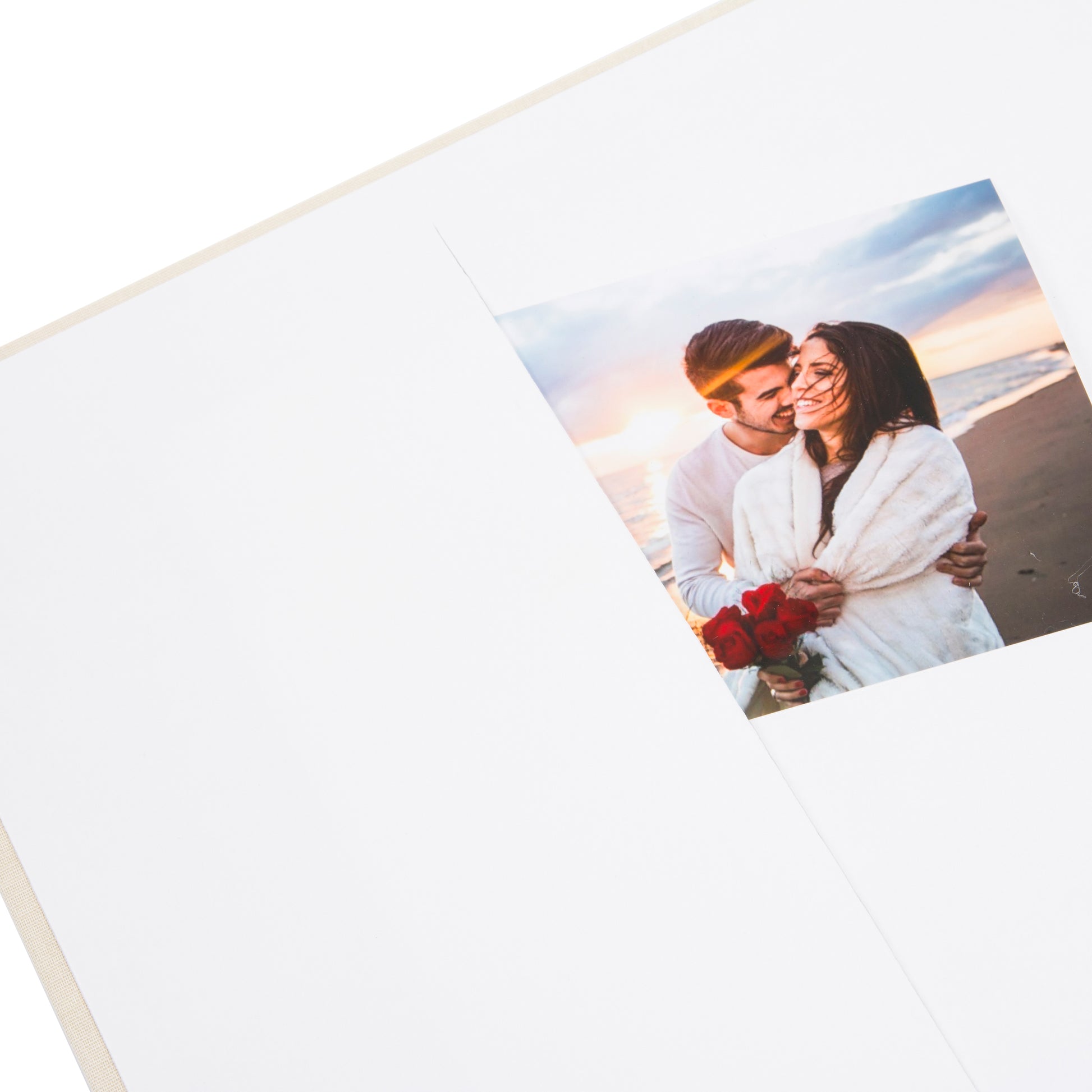 A Goldbuch photo album with three photographs showcased on its surface.