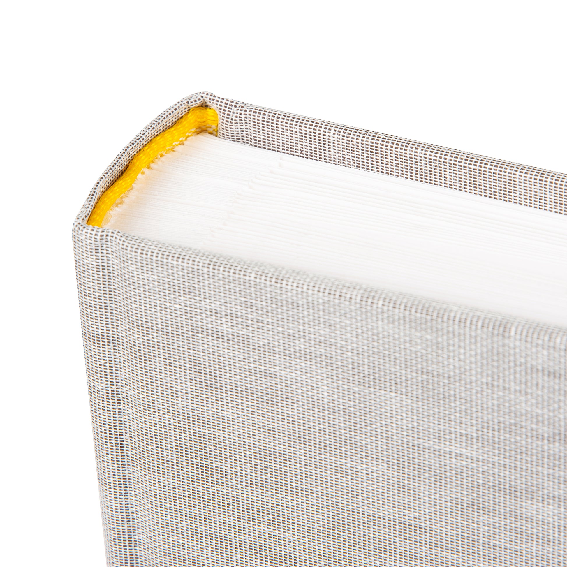 A grey Goldbuch photo album with three photographs showcased on its surface.