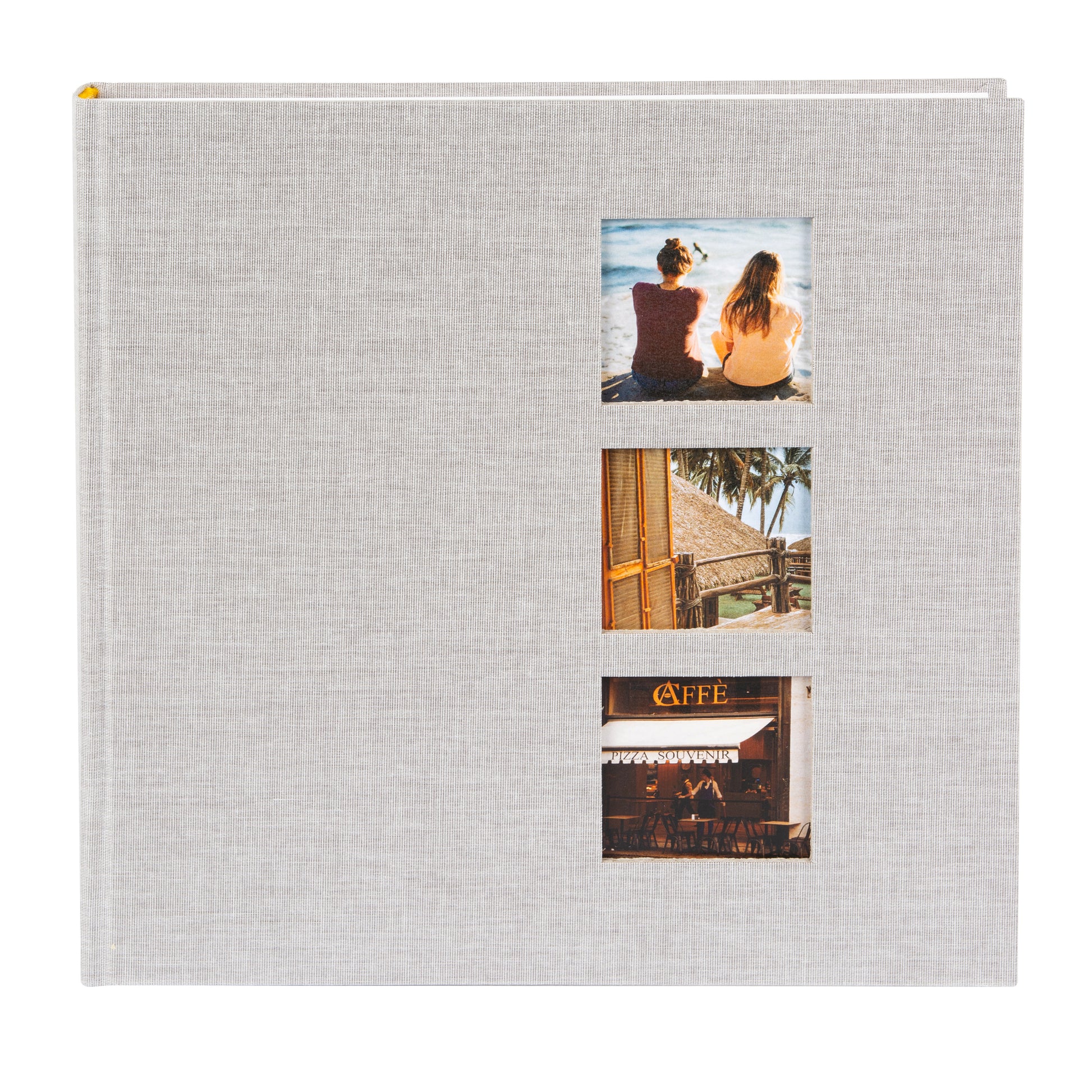 A grey Goldbuch photo album with three photographs showcased on its surface.