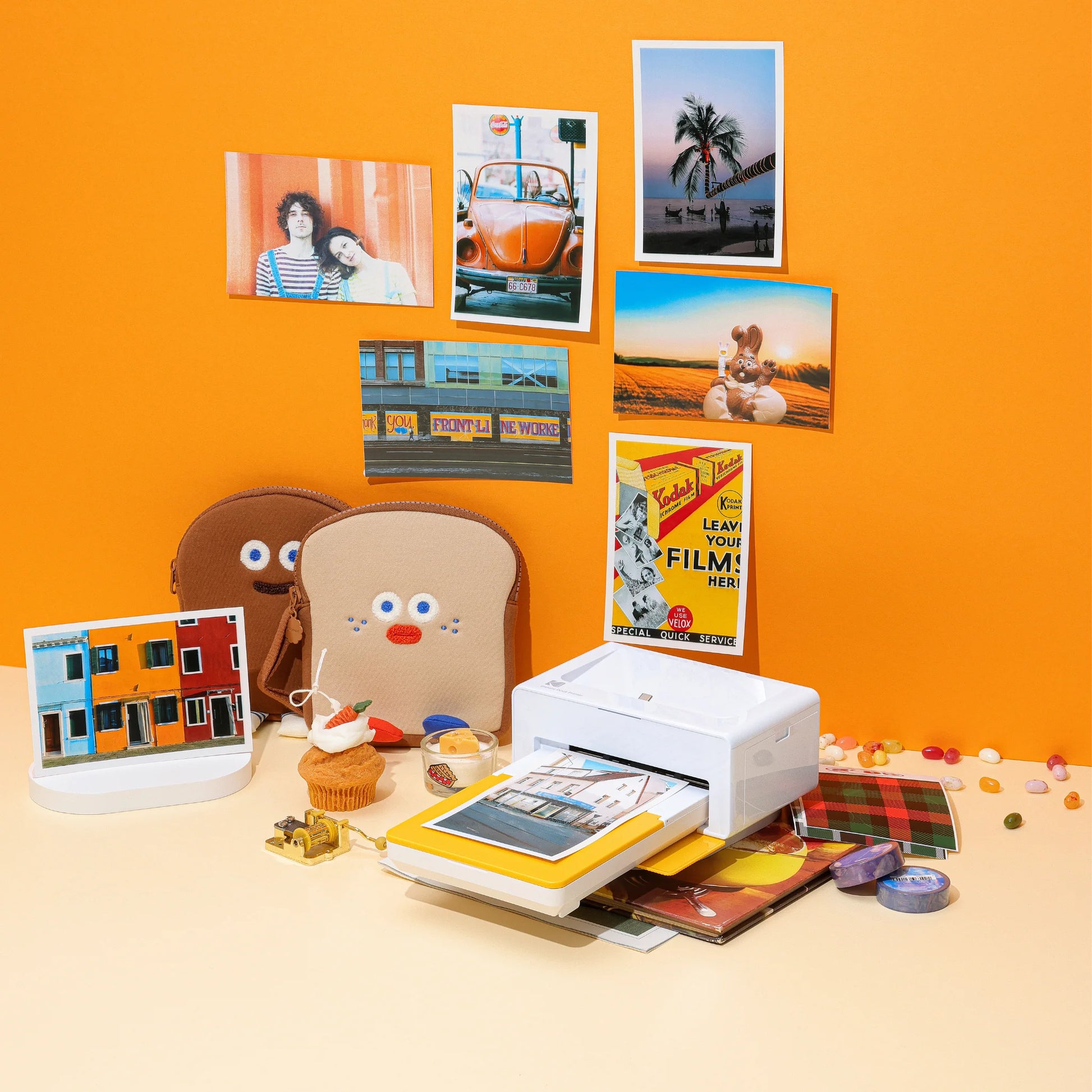 A woman displays a photo just printed from a Kodak instant printer, highlighting the joy of instant photography.
