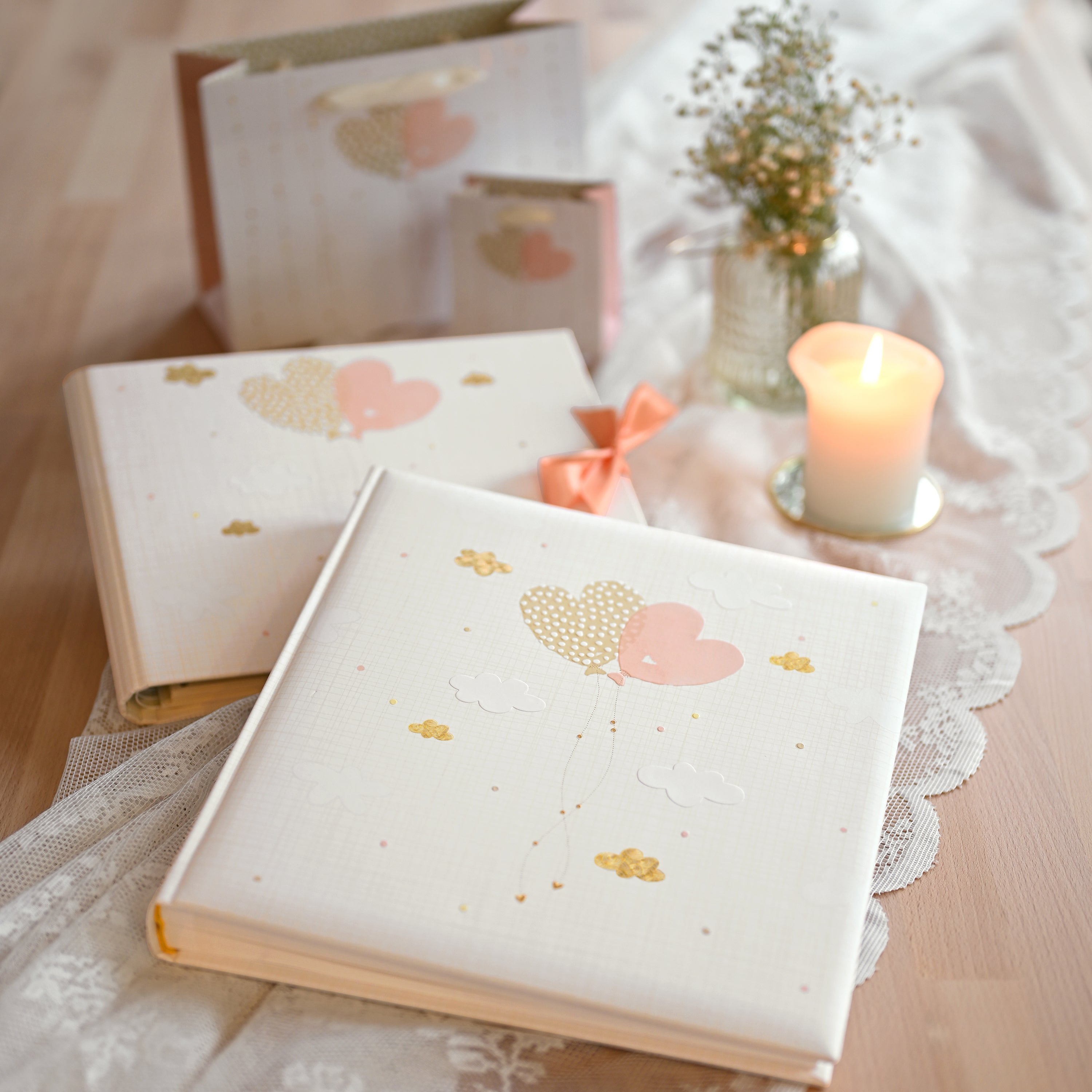 A Goldbuch white photo album with heart shaped balloon design, decorated with golden clouds, ideal for your treasured moments.