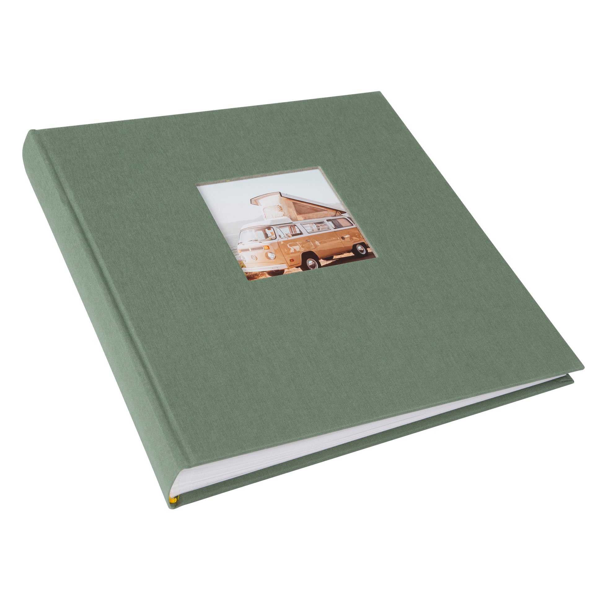 A green Goldbuch photo album in focus, with a retro van visible in the background, representing a blend of memories and exploration.