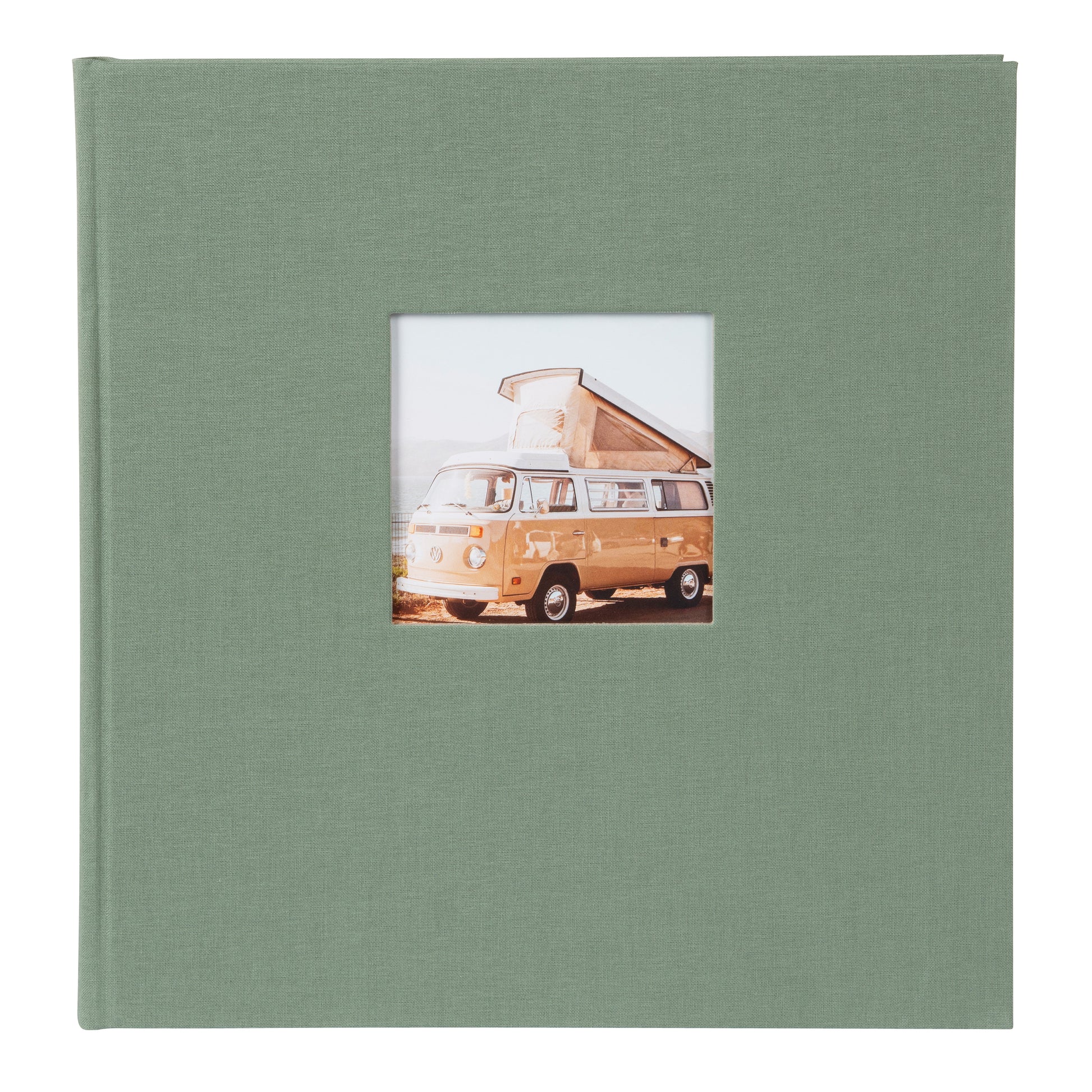 A green Goldbuch photo album in focus, with a retro van visible in the background, representing a blend of memories and exploration.