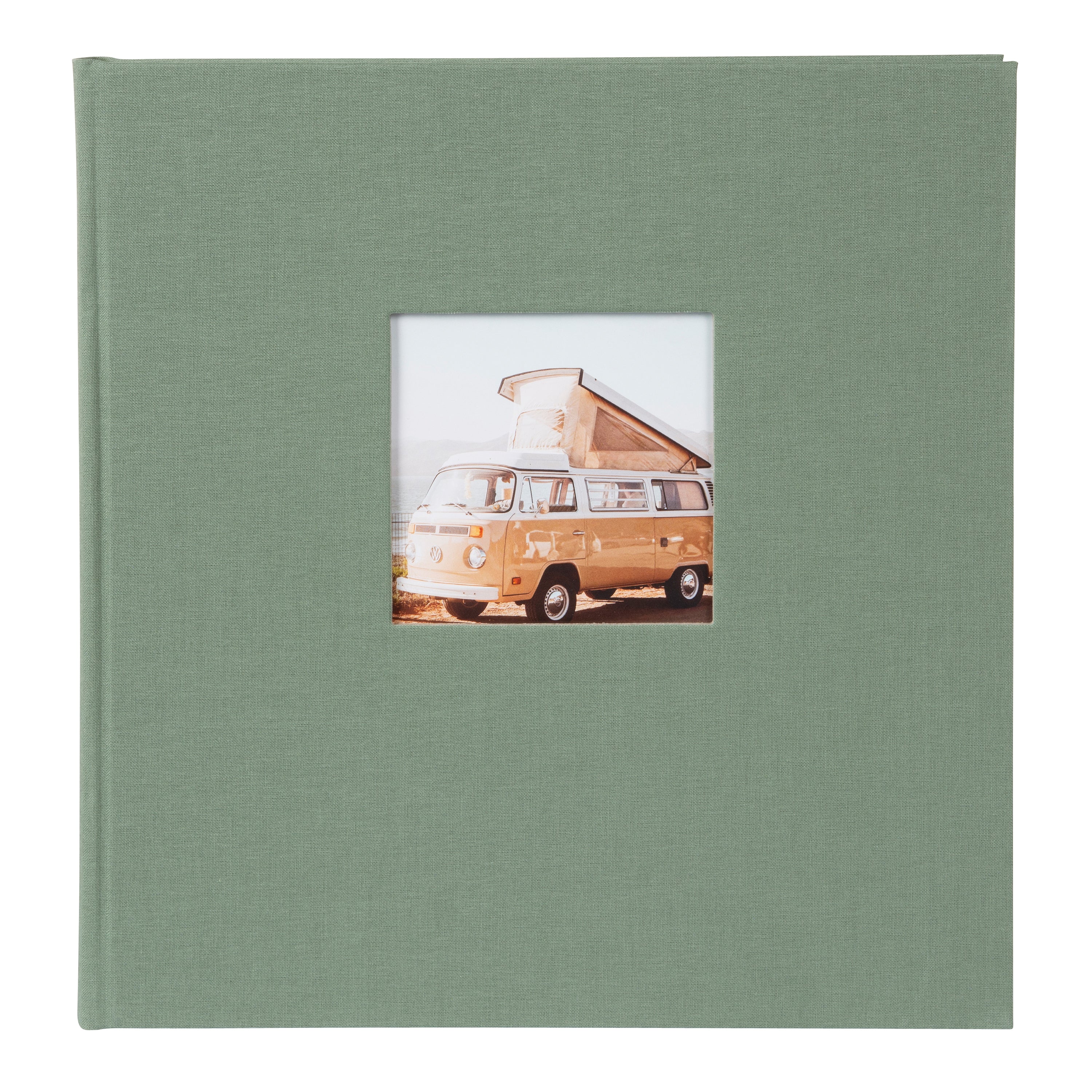 A green Goldbuch photo album in focus, with a retro van visible in the background, representing a blend of memories and exploration.