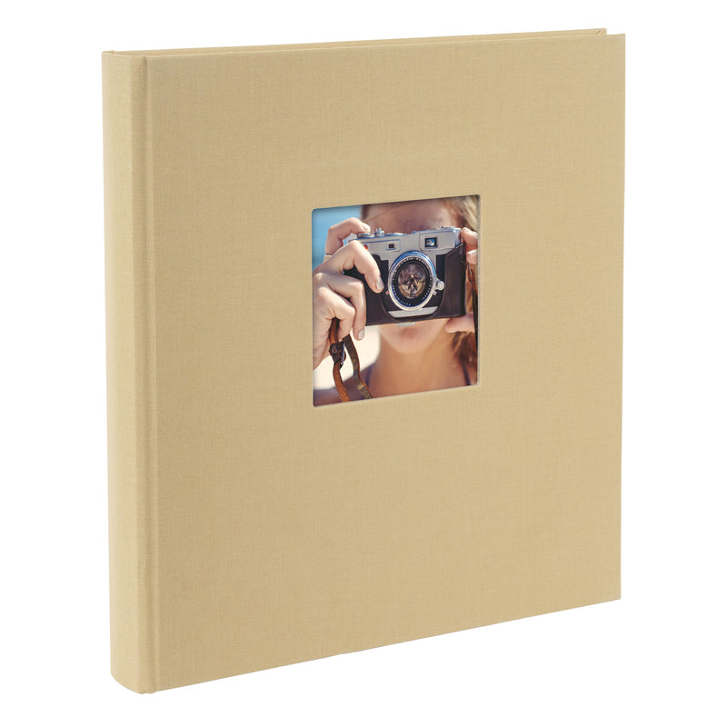 A Goldbuch beige photo album with a cover illustration of a girl taking photos showcasing its hardcover design and black pages.