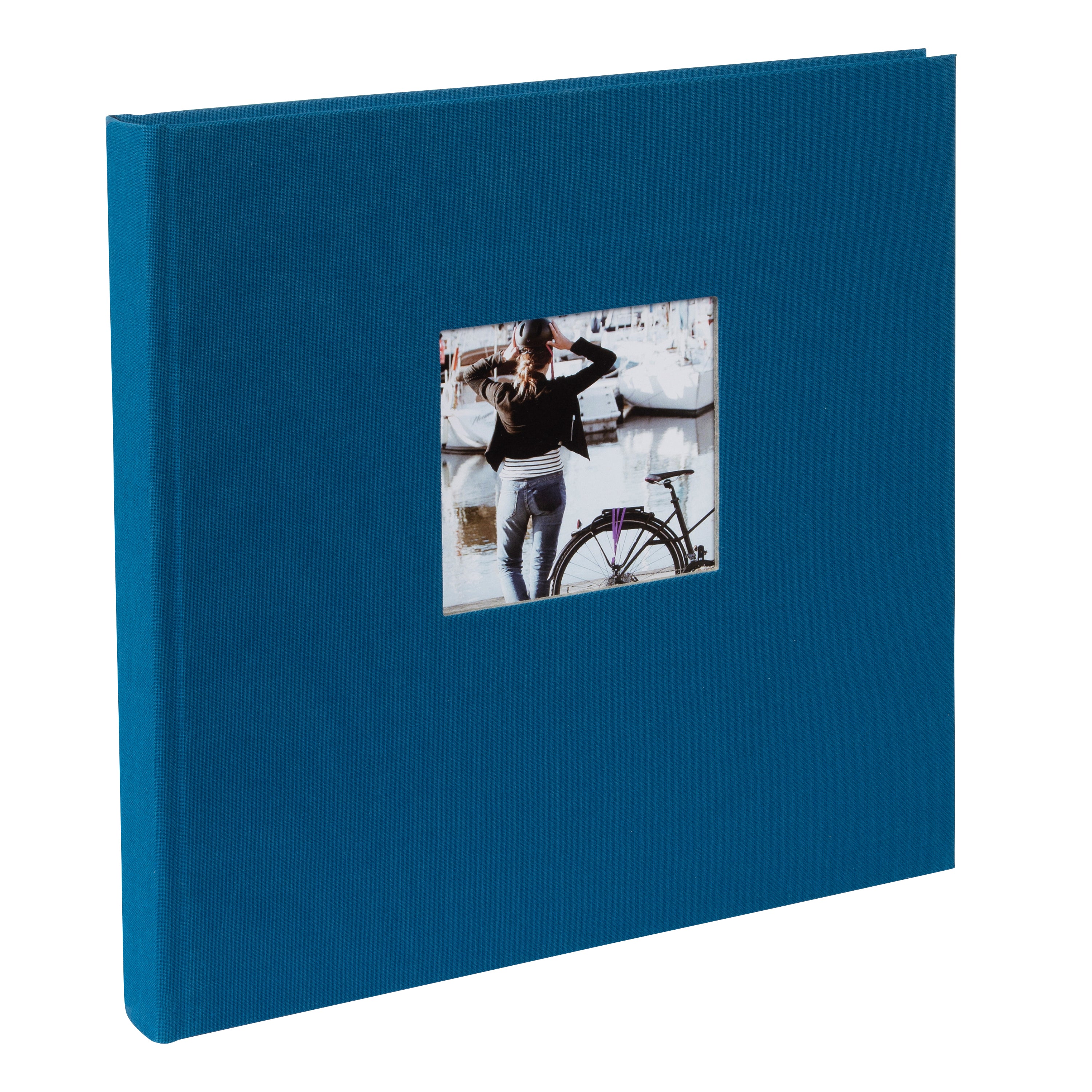 A Goldbuch blue photo album with a cover illustration of a woman cycling, showcasing its hardcover design.