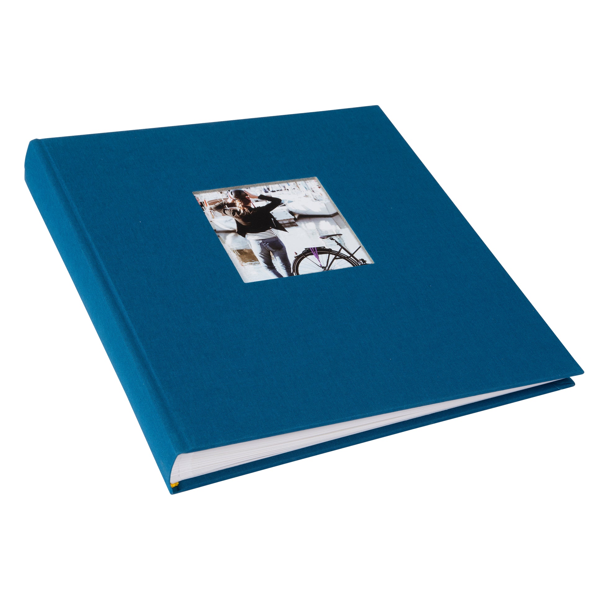 A Goldbuch blue photo album with a cover illustration of a woman cycling, showcasing its hardcover design.