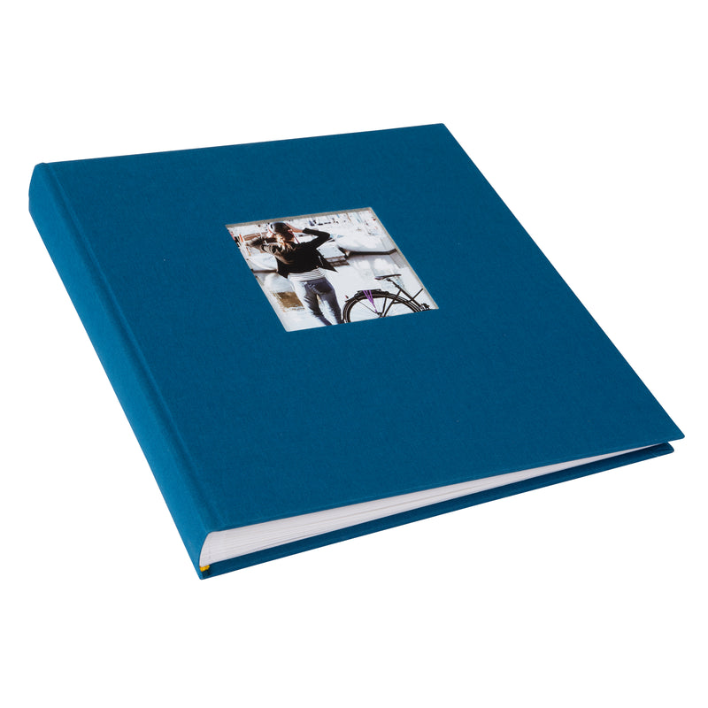 A Goldbuch blue photo album with a cover illustration of a woman cycling, showcasing its hardcover design.