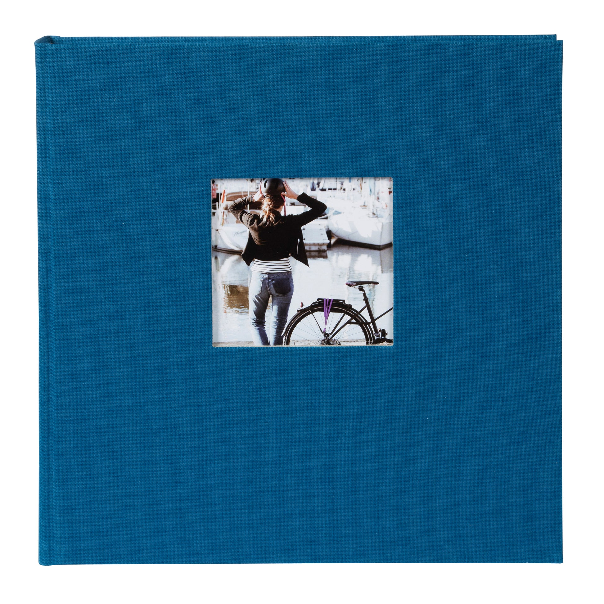 A Goldbuch blue photo album with a cover illustration of a woman cycling, showcasing its hardcover design.