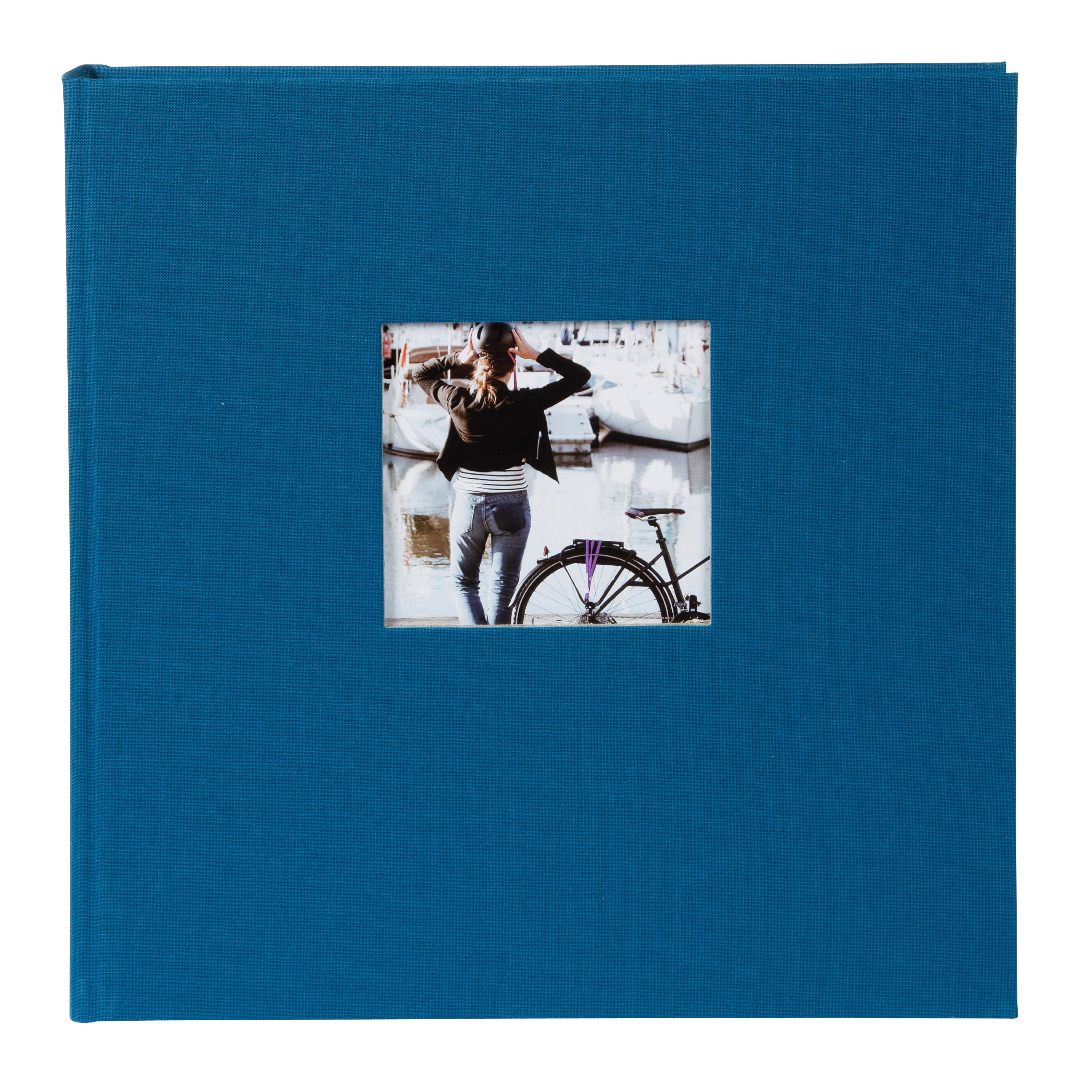 A Goldbuch blue photo album with a cover illustration of a woman cycling, showcasing its hardcover design.