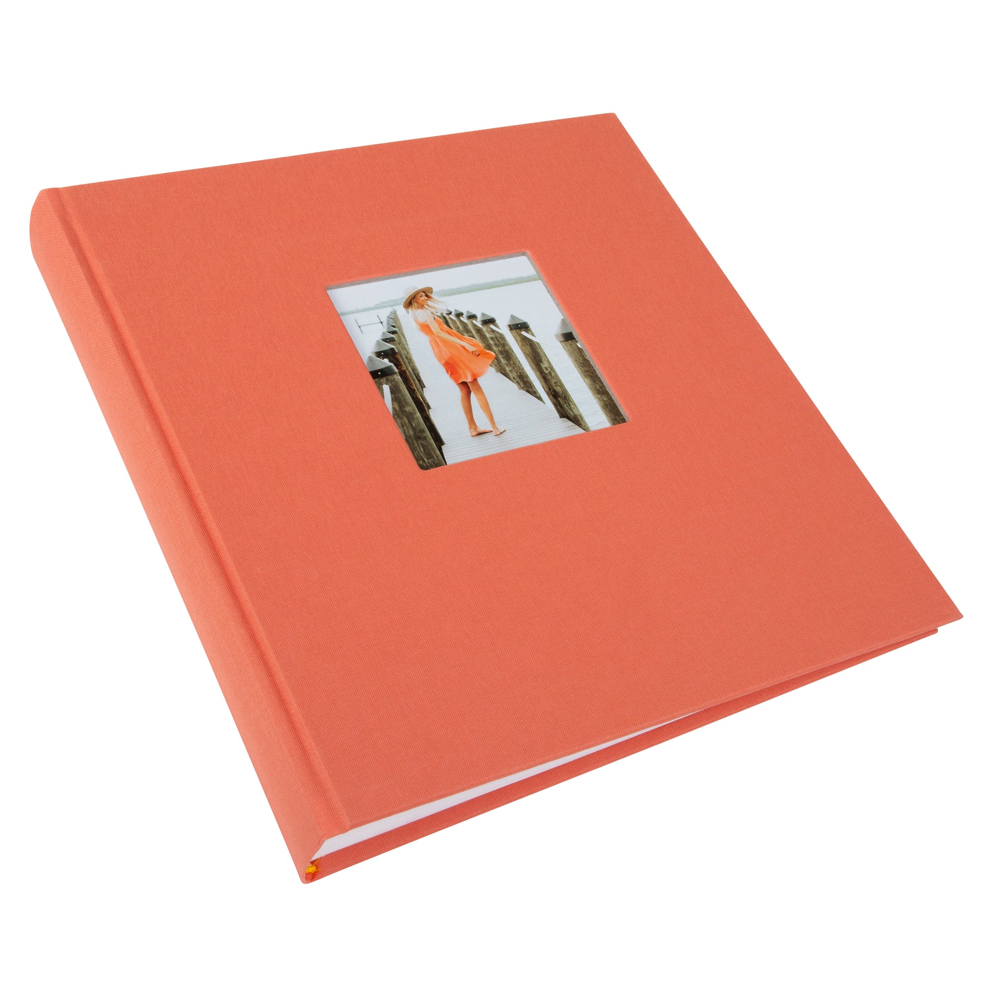  A salmon color Goldbuch hardcover photo album featuring an image of a woman walking on a pier.