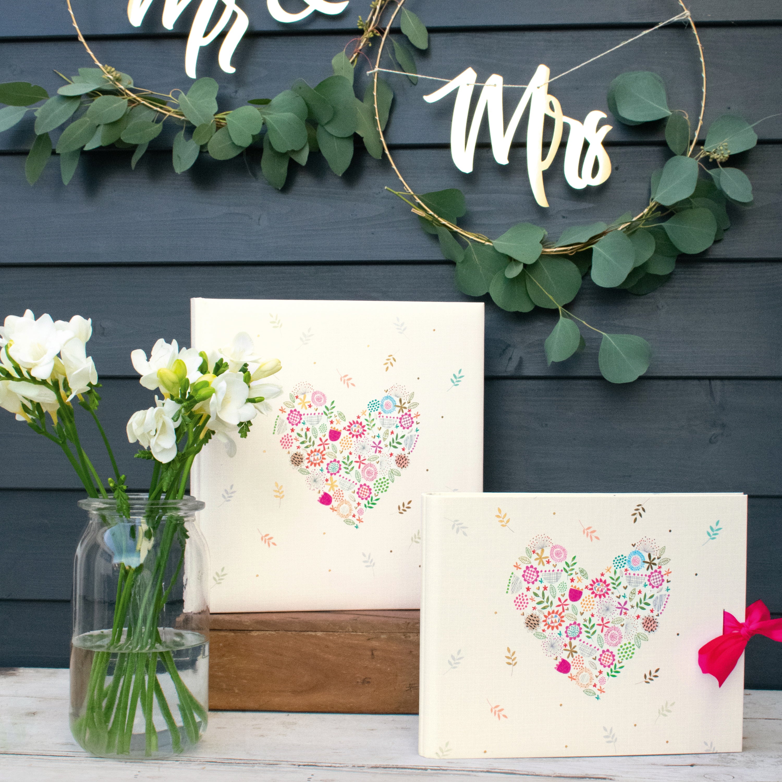 A Goldbuch white photo album with heart shaped flower design, decorated with flowers, ideal for your treasured moments.