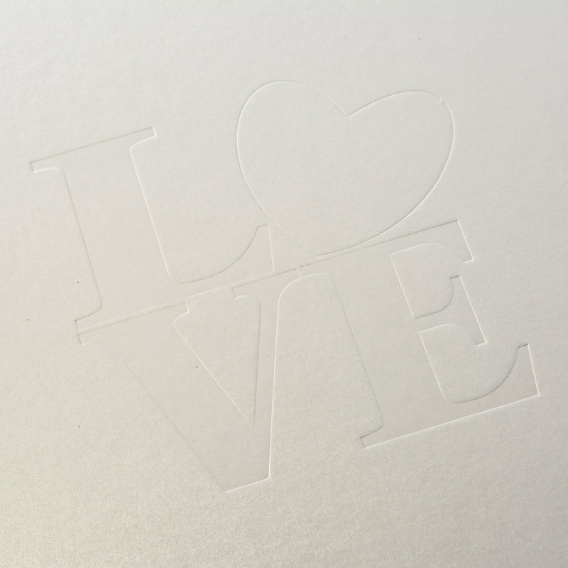 A white Goldbuch wedding photo album showcasing the word "love" beautifully positioned in the middle of the cover.