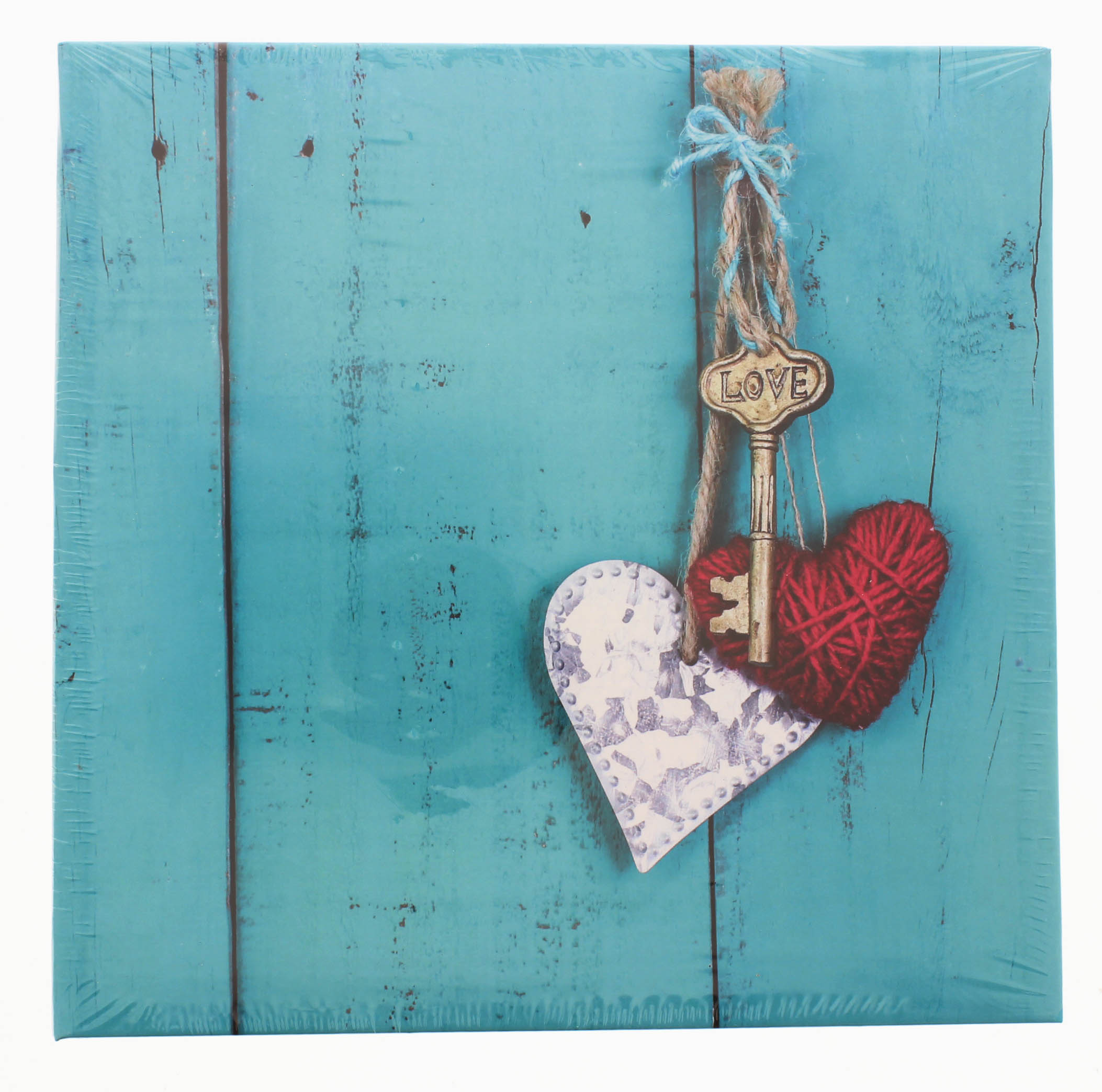 A wooden heart and key are displayed on a blue background, representing cherished moments on a Hama photo album.