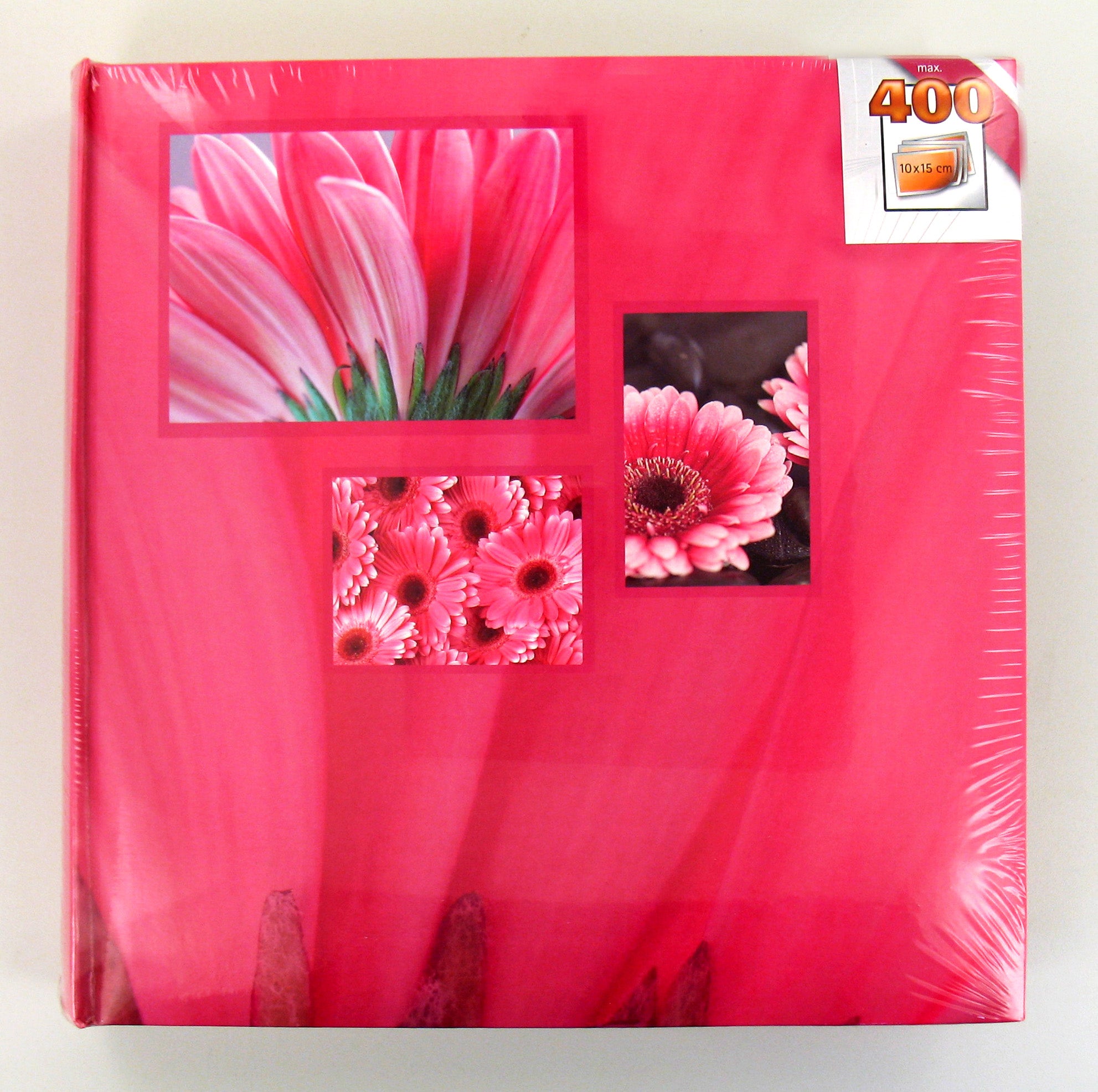 A pink Hama photo album displaying various pictures of pink flowers, highlighting their unique shapes.