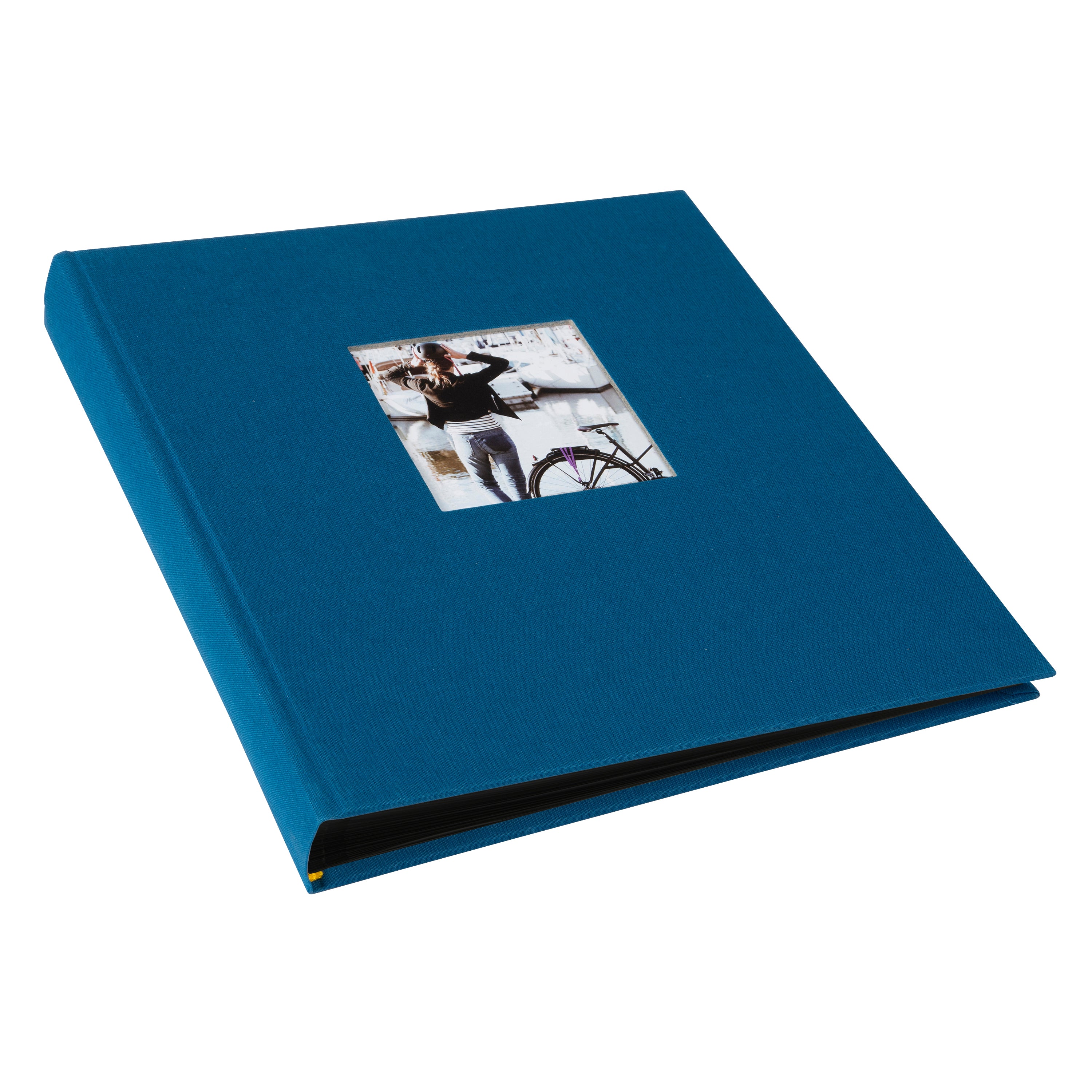 A Goldbuch blue photo album with a cover illustration of a woman cycling, showcasing its hardcover design and black pages.