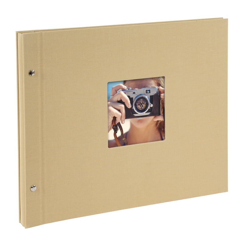 A Goldbuch beige photo album with a cover illustration of a woman taking photos, showcasing its hardcover design and black pages.