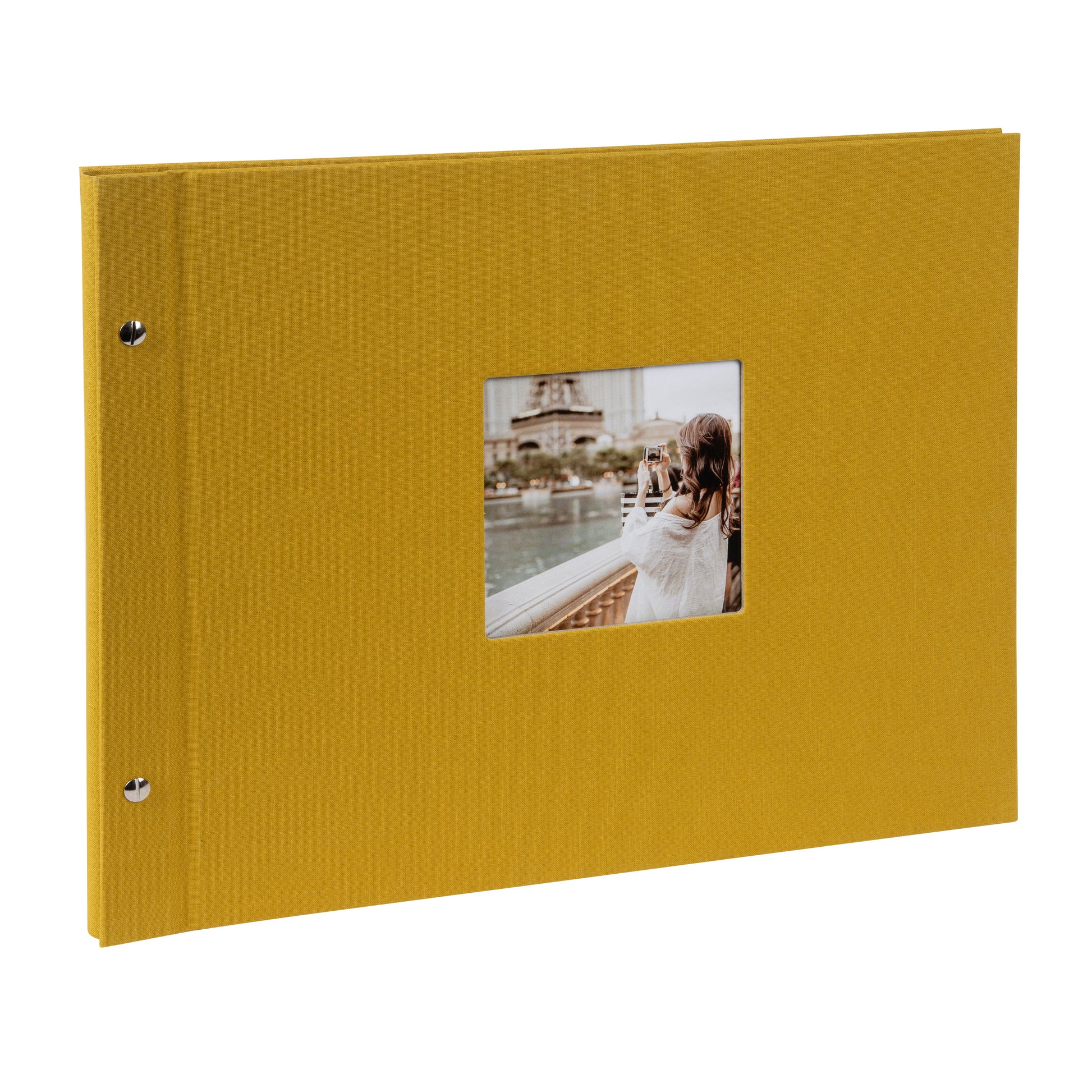 A Goldbuch mustard photo album with a cover illustration of a woman taking photos, showcasing its hardcover design and black pages.