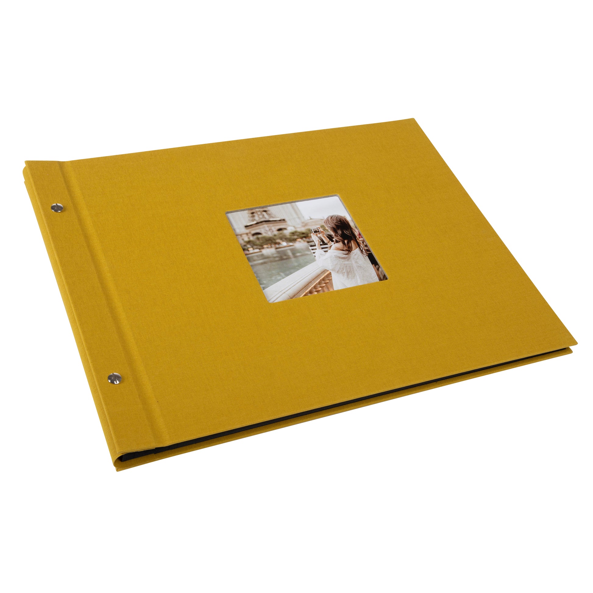 A Goldbuch mustard photo album with a cover illustration of a woman taking photos, showcasing its hardcover design and black pages.