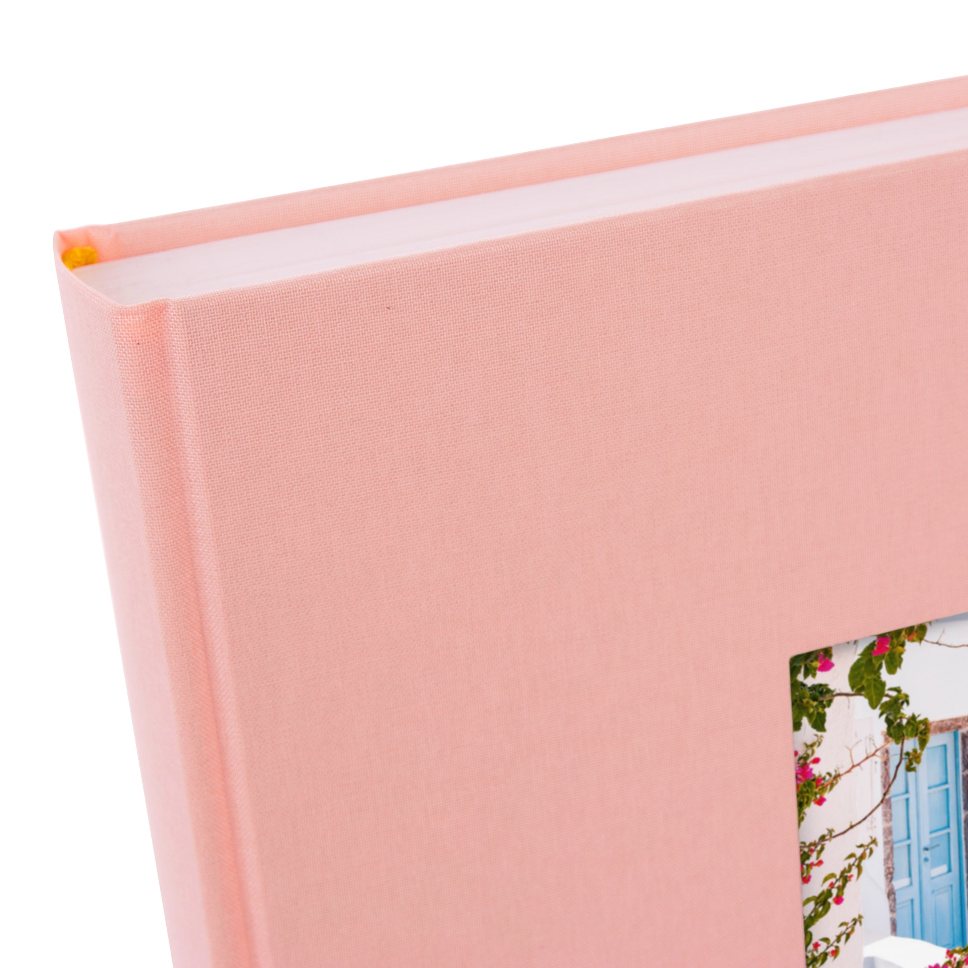 A Goldbuch rose photo album with a cover illustration of a blue wooden gate, showcasing its hardcover design and white pages.