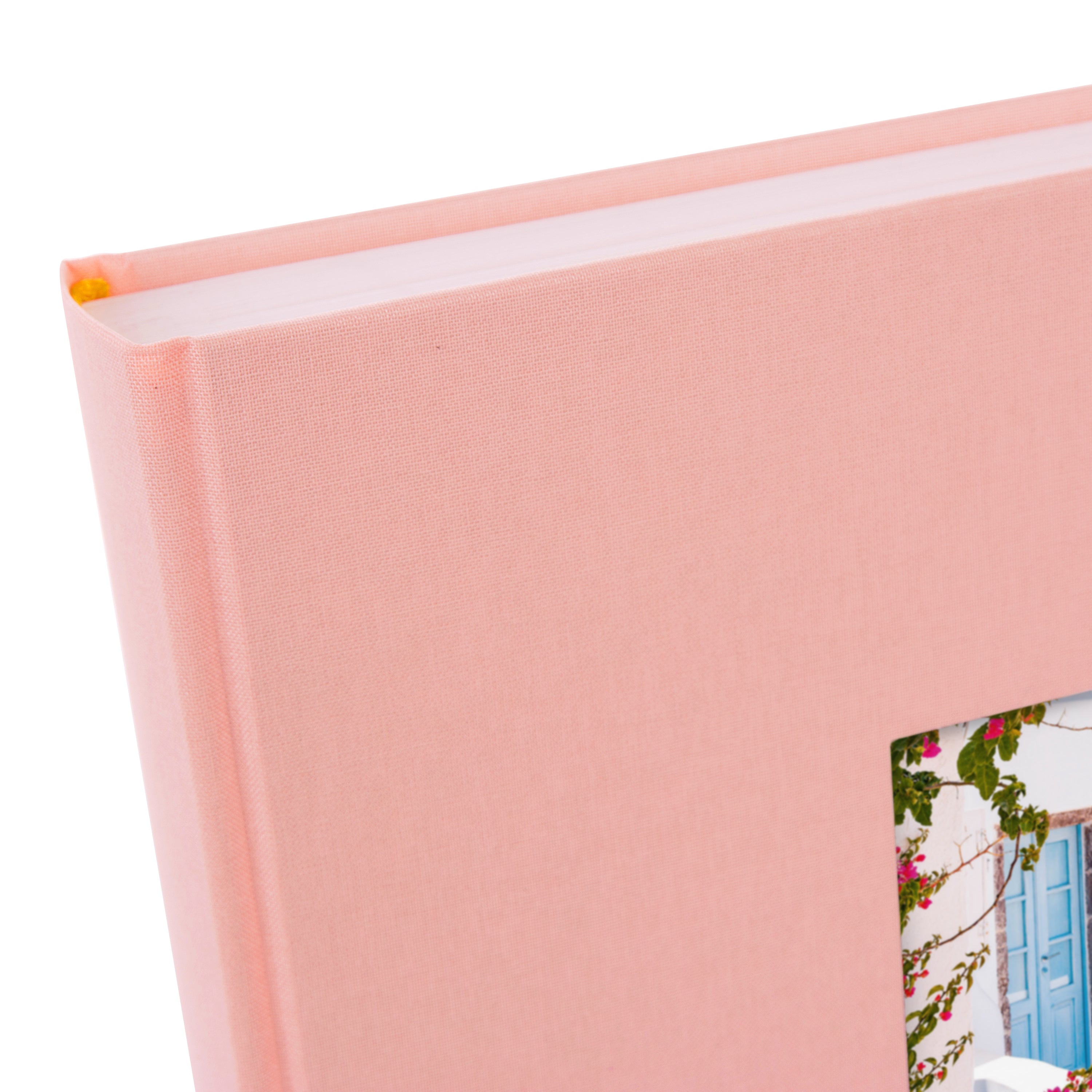 A Goldbuch rose photo album with a cover illustration of a blue wooden gate, showcasing its hardcover design and white pages.