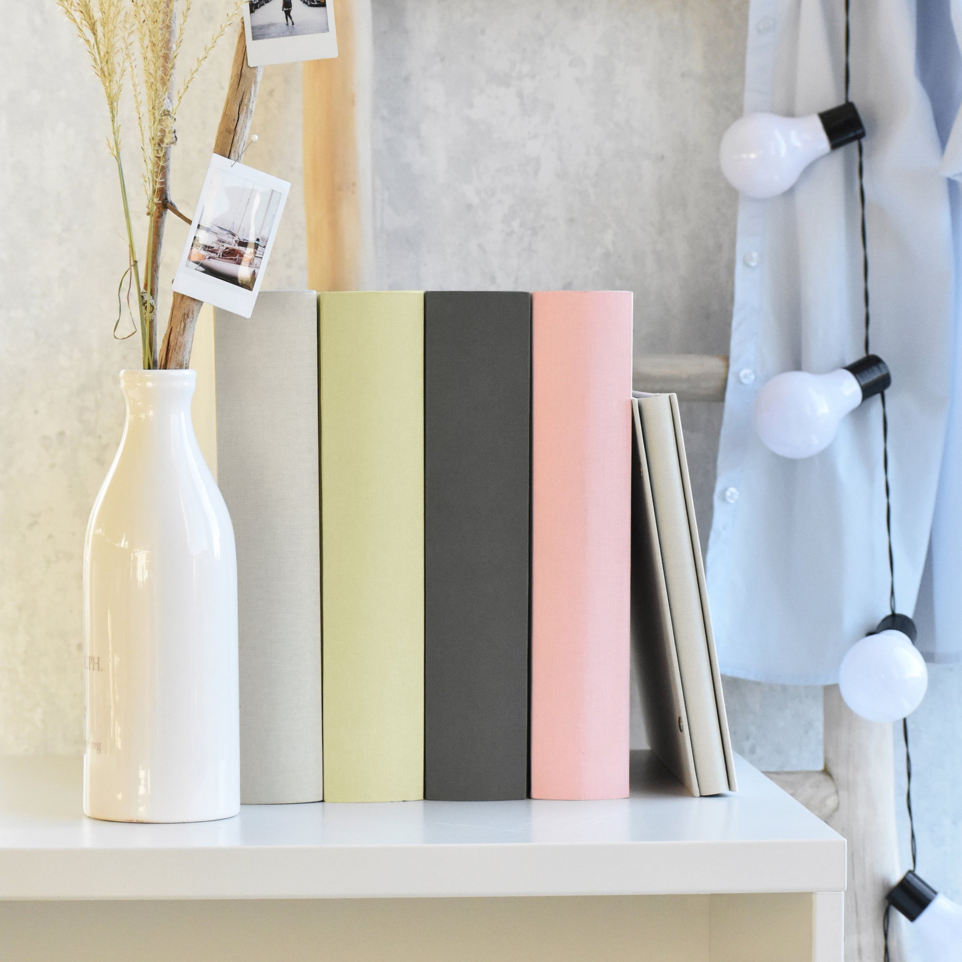 A Goldbuch rose photo album with a cover illustration of a blue wooden gate, showcasing its hardcover design and white pages.