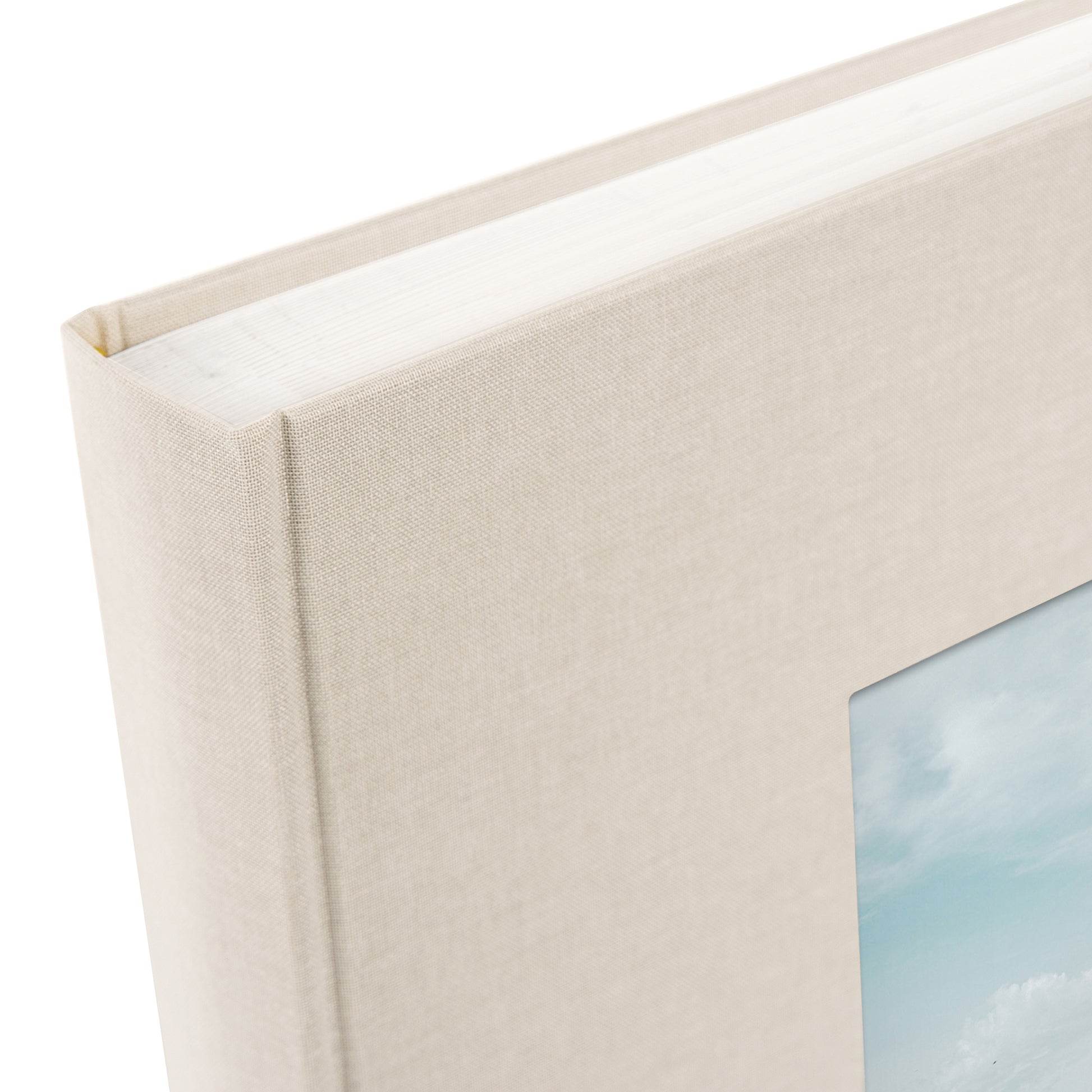 A Goldbuch sandgrey photo album with a cover illustration of the Eiffel tower, showcasing its hardcover design and white pages.