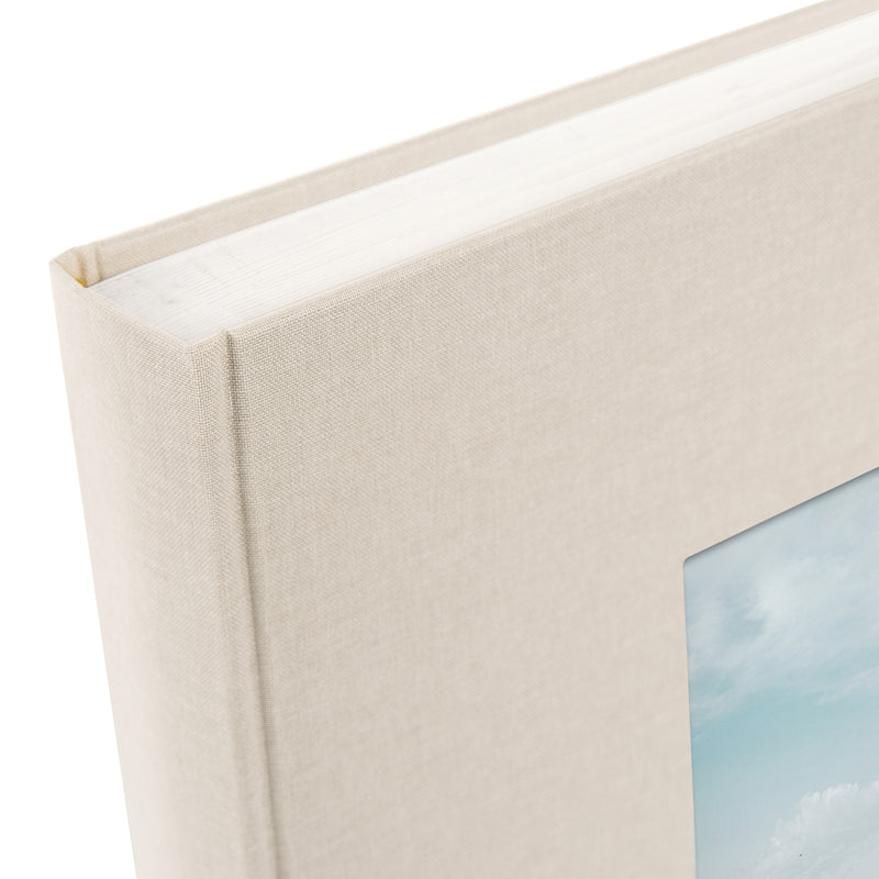 A Goldbuch sandgrey photo album with a cover illustration of the Eiffel tower, showcasing its hardcover design and white pages.