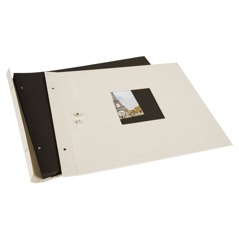 A Goldbuch sandgrey photo album with a cover illustration of the Eiffel tower, showcasing its hardcover design and black pages.