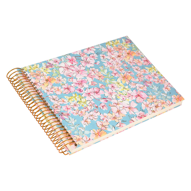 A spiral Goldbuch photo album, adorned with pink and blue flowers.
