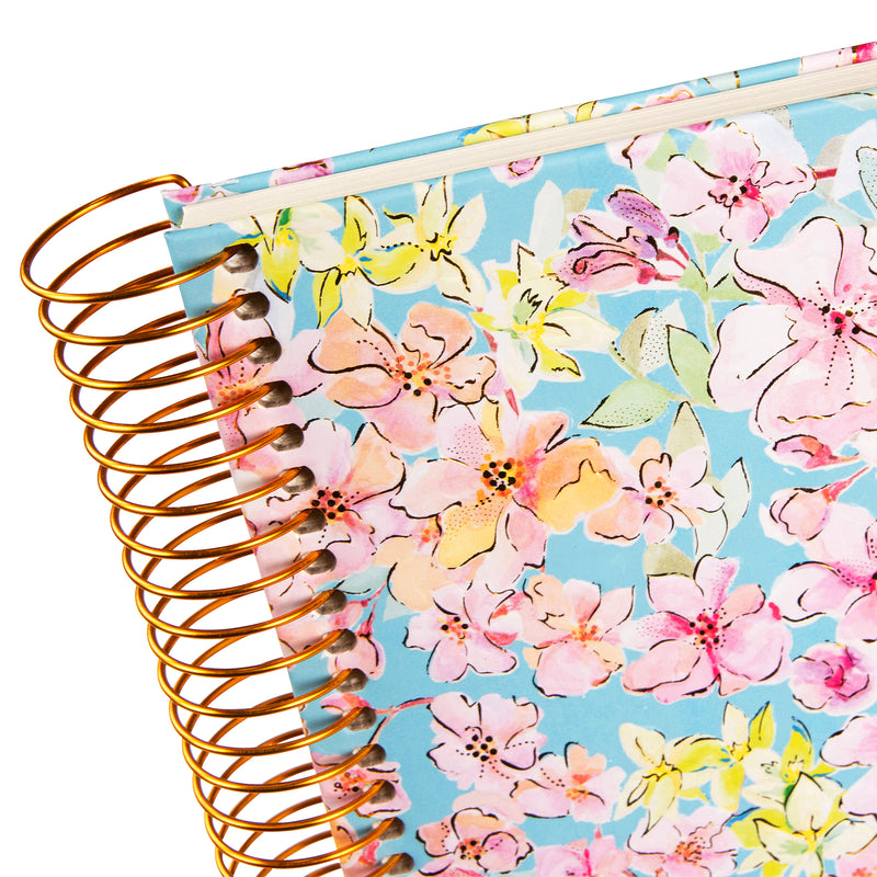 A spiral Goldbuch photo album, adorned with pink and blue flowers.
