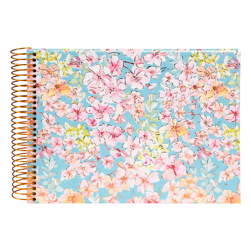 A spiral Goldbuch photo album, adorned with pink and blue flowers.

