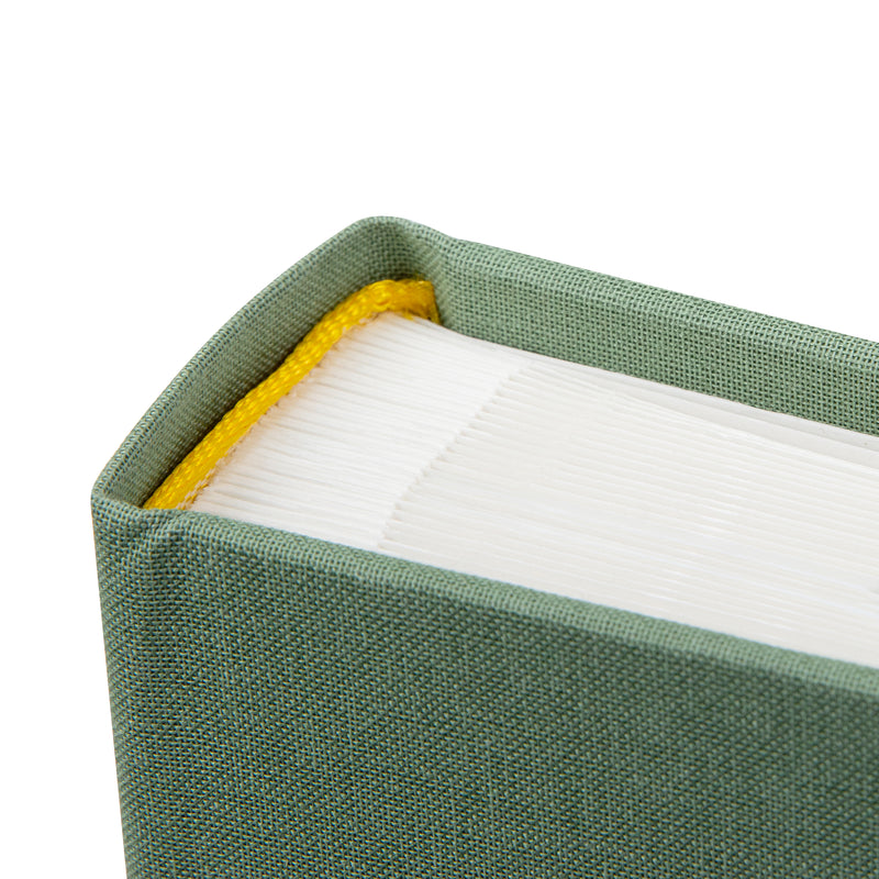 Goldbuch green photo album with a cutout featuring a couple and a heart symbol on a white background