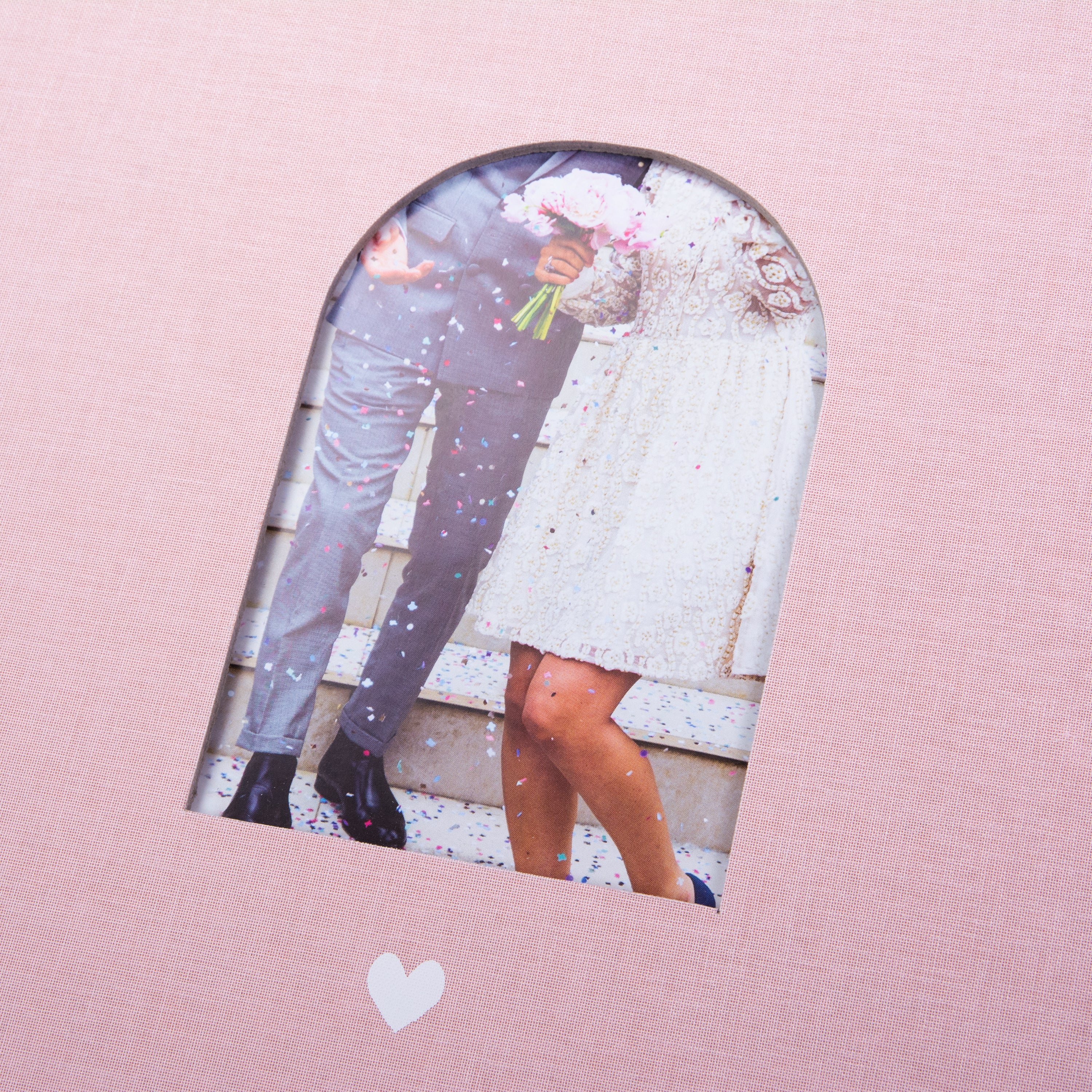 Goldbuch Pink photo album with a cutout featuring a couple and a heart symbol on a white background