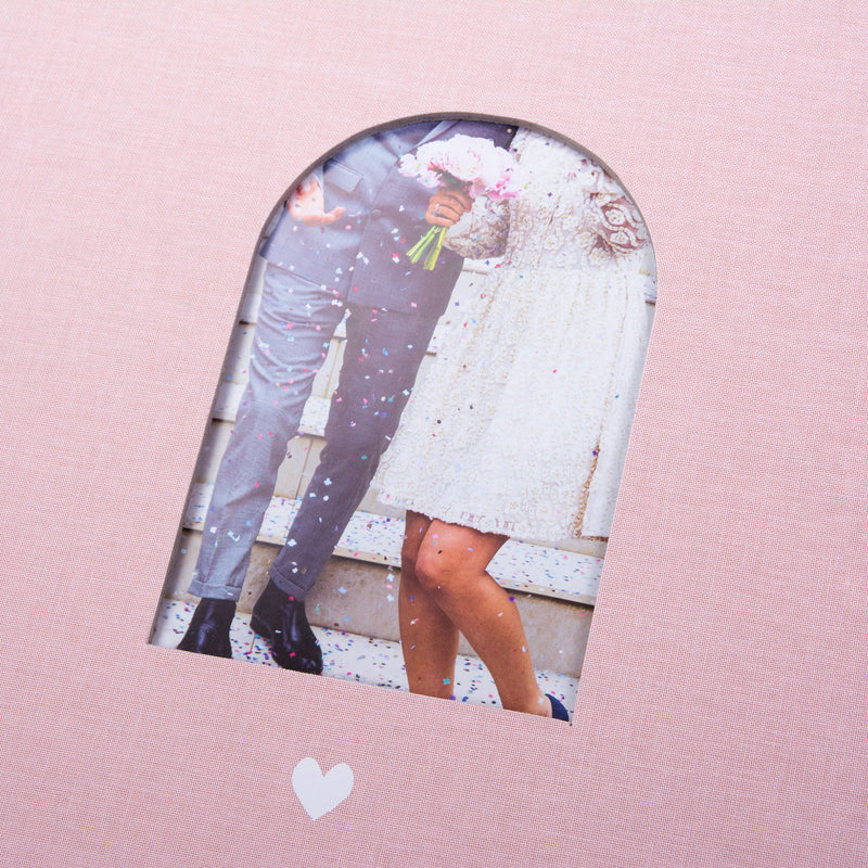 Goldbuch Pink photo album with a cutout featuring a couple and a heart symbol on a white background