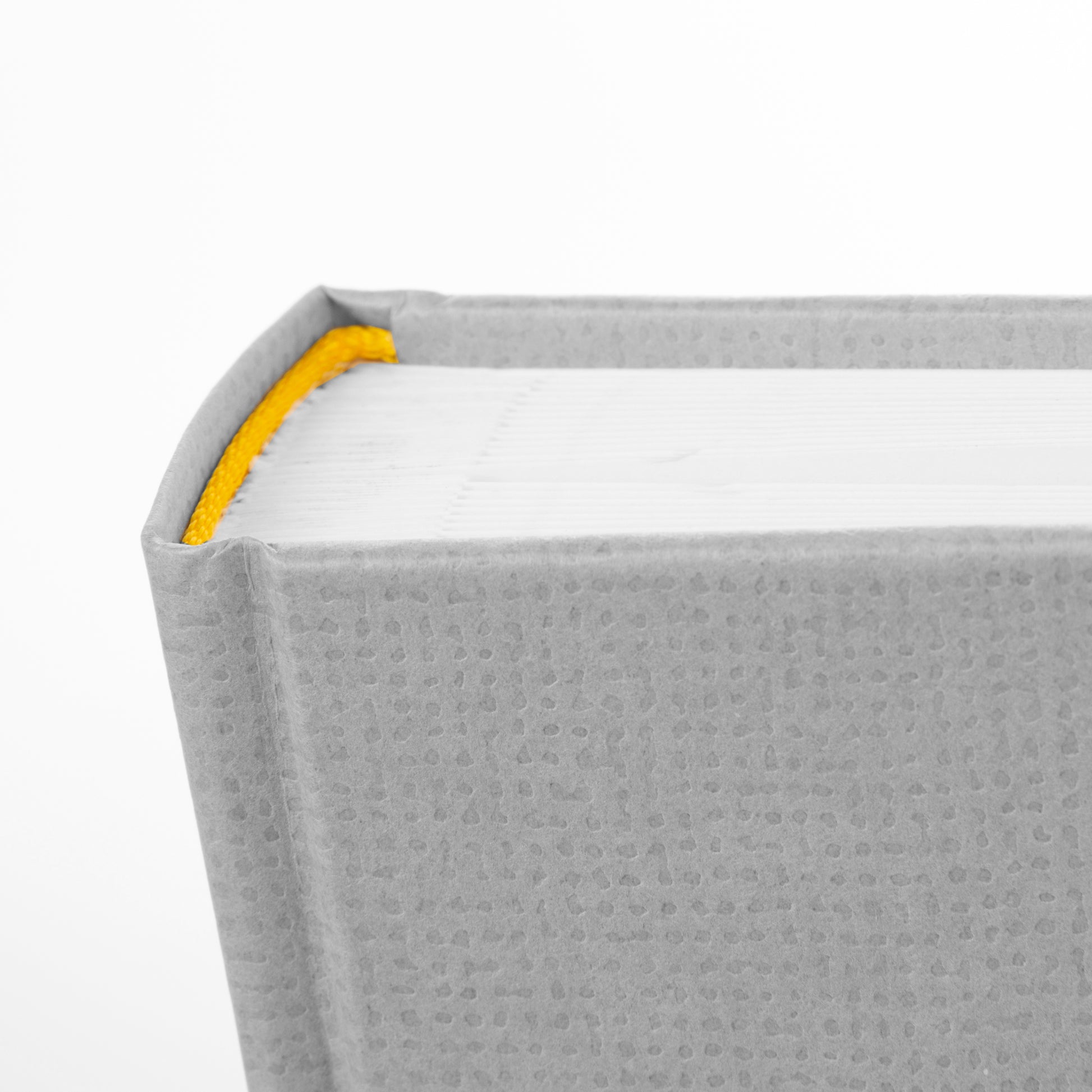 A grey Goldbuch photo album with an illustration of a man and a woman on its front cover.