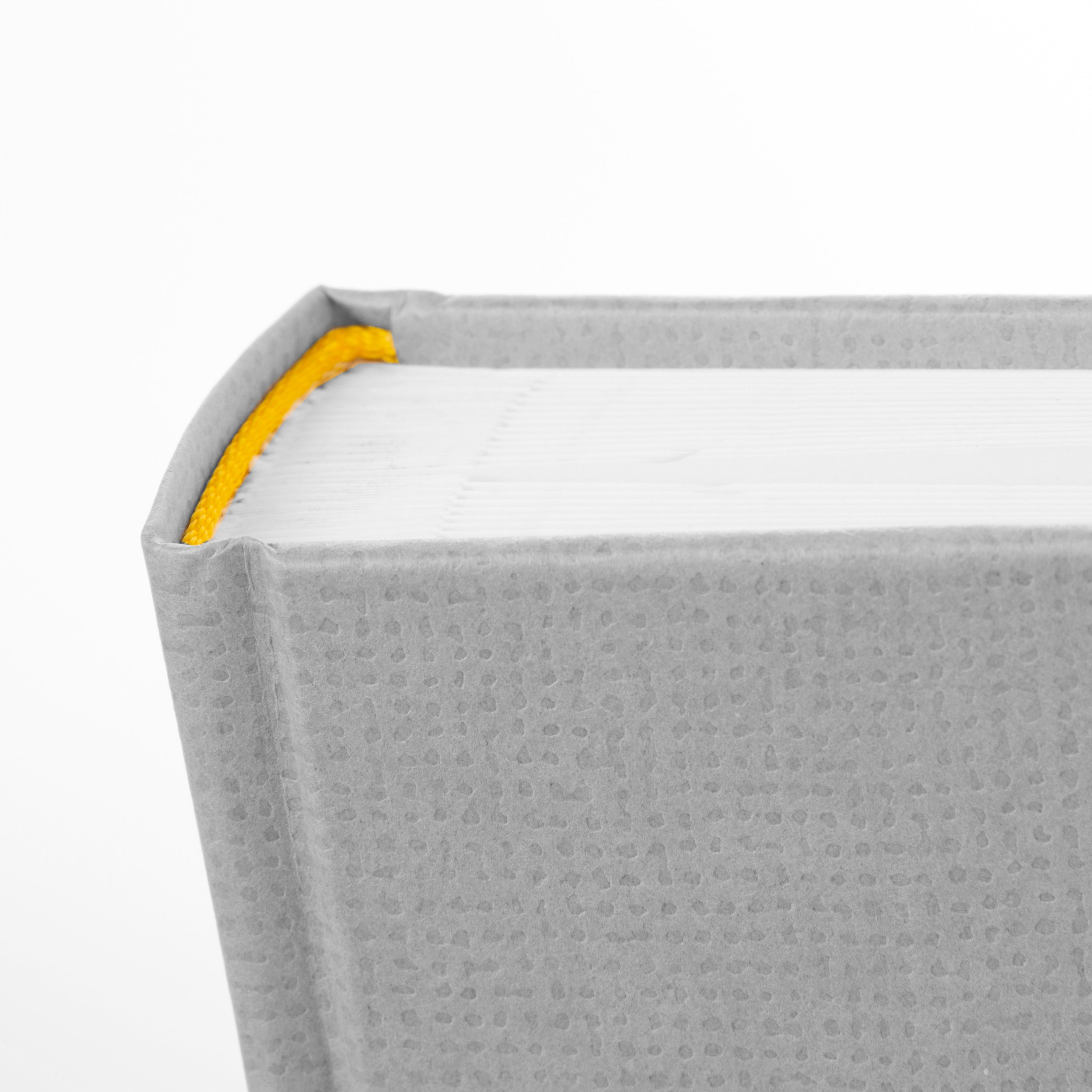 A grey Goldbuch photo album with an illustration of a man and a woman on its front cover.