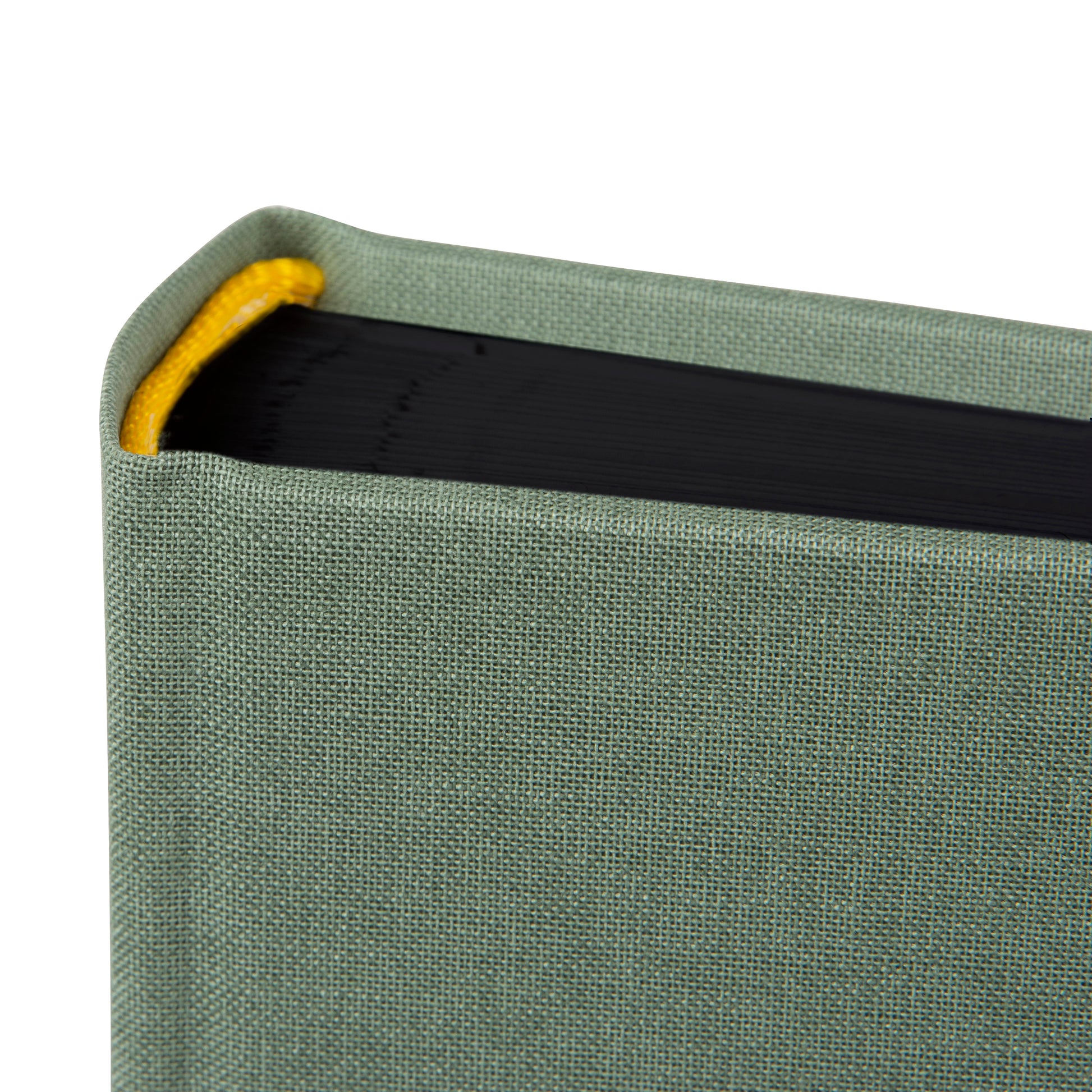 A Goldbuch artichoke green photo album with a cover illustration of a van with a tent on the roof, showcasing its hardcover design and black pages.