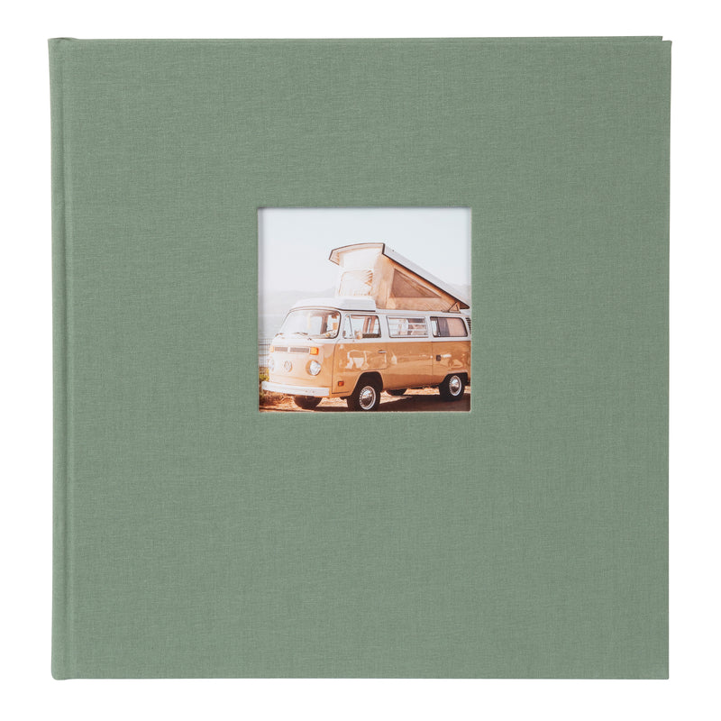 A Goldbuch artichoke green photo album with a cover illustration of a van with a tent on the roof, showcasing its hardcover design and black pages.