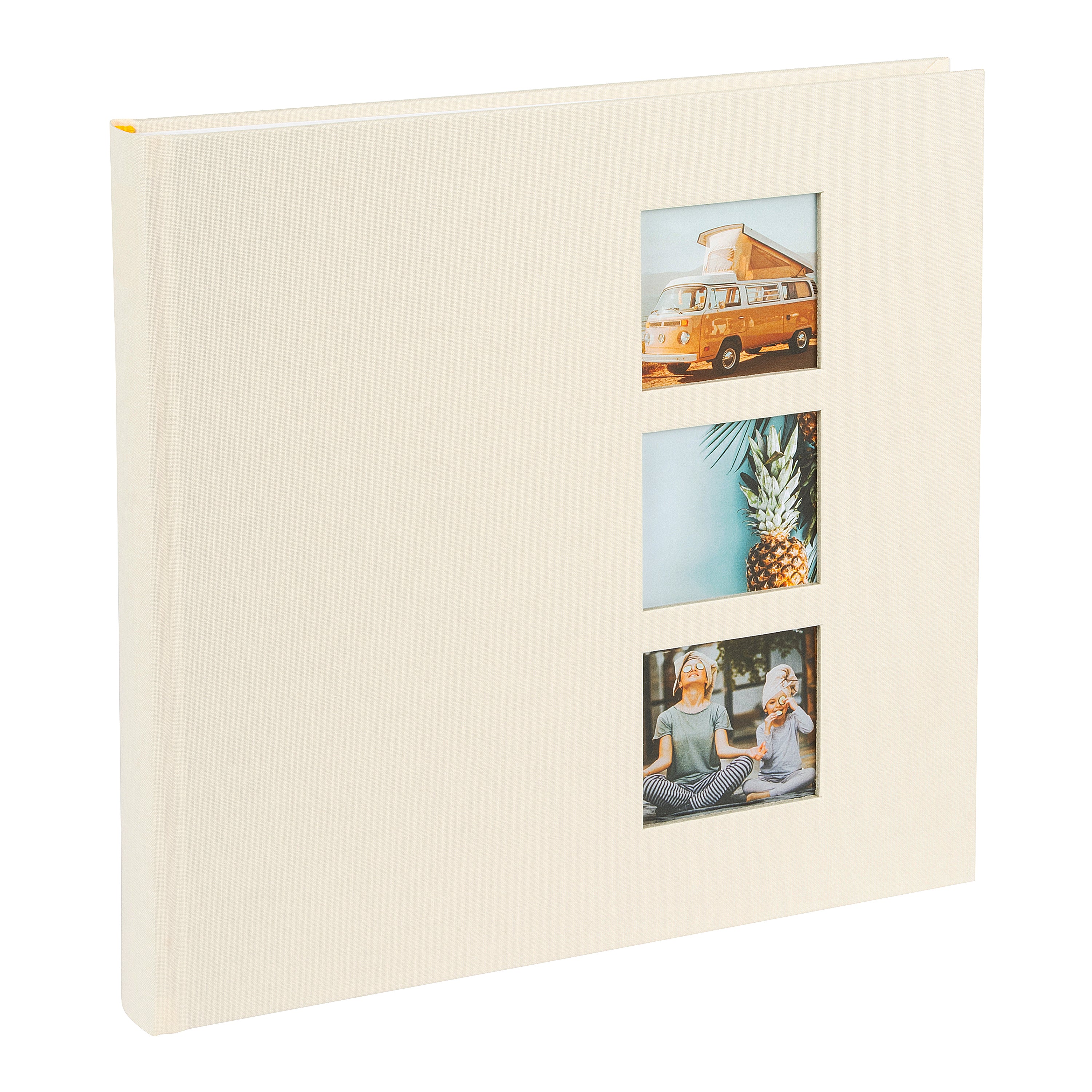 A Goldbuch photo album with three photographs showcased on its surface.