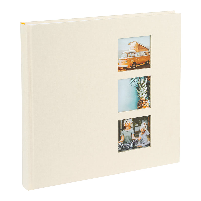 A Goldbuch photo album with three photographs showcased on its surface.