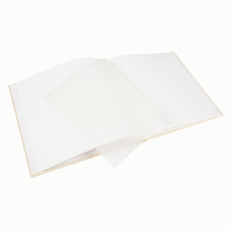 A Goldbuch photo album with three photographs showcased on its surface.